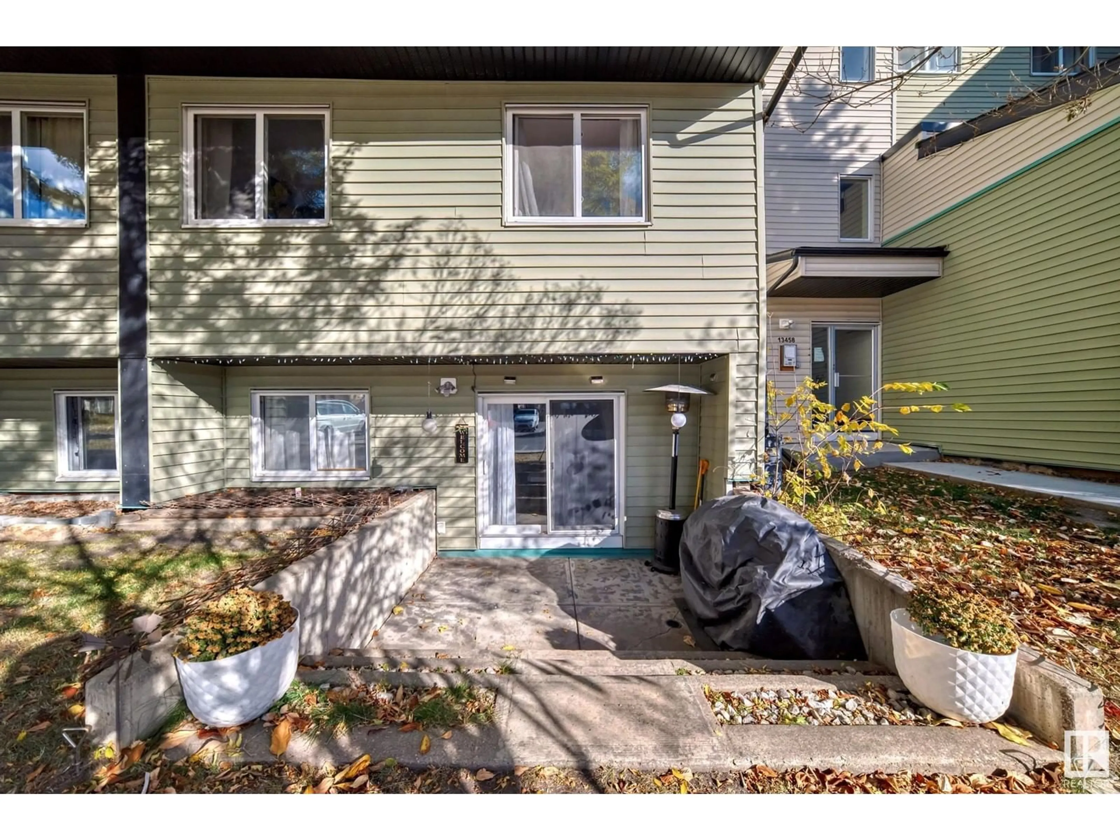 A pic from exterior of the house or condo, the fenced backyard for #1 13458 FORT RD NW, Edmonton Alberta T5A1C5