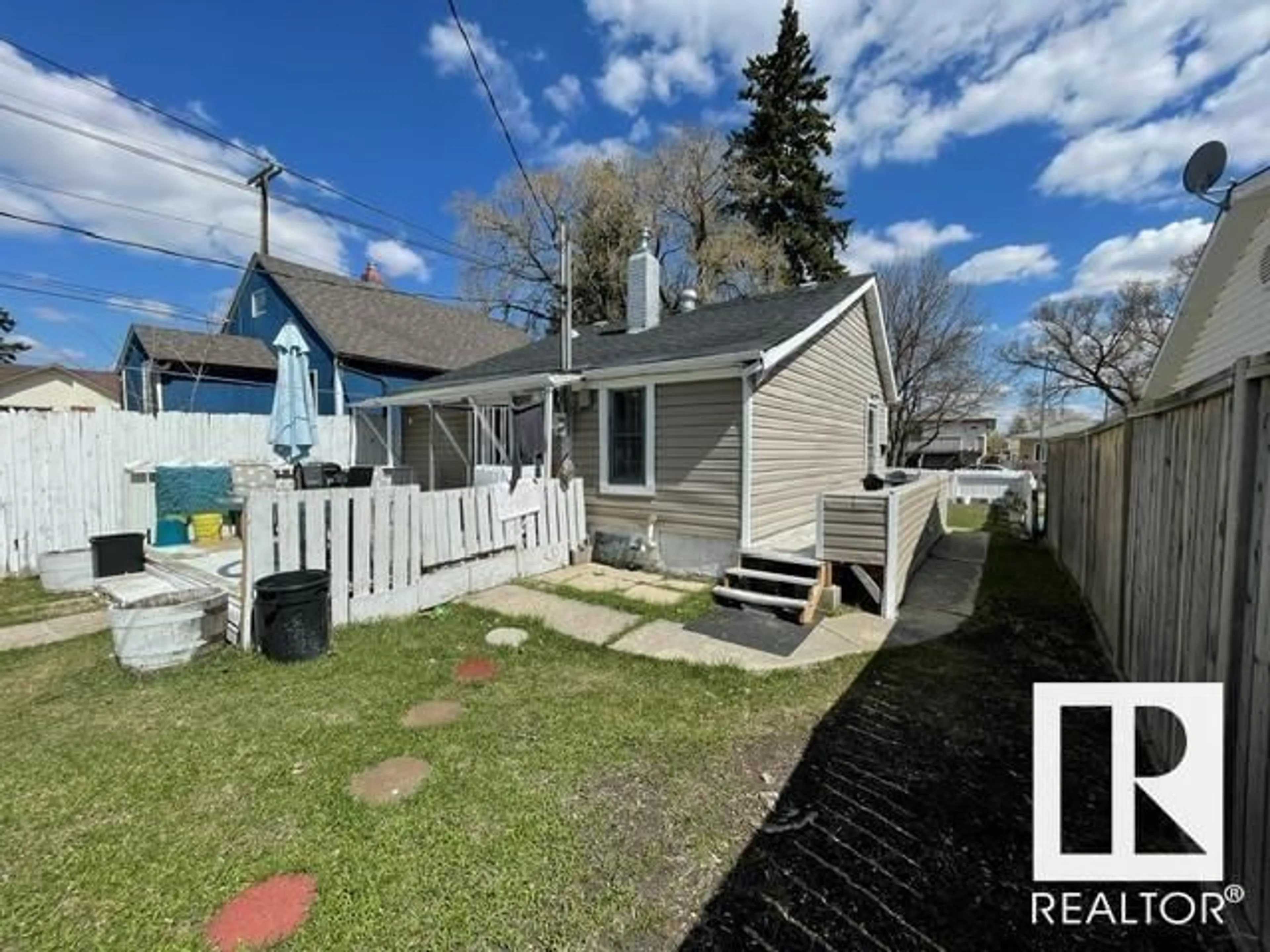 Frontside or backside of a home, the fenced backyard for 11944 77 ST NW, Edmonton Alberta T5B2G4