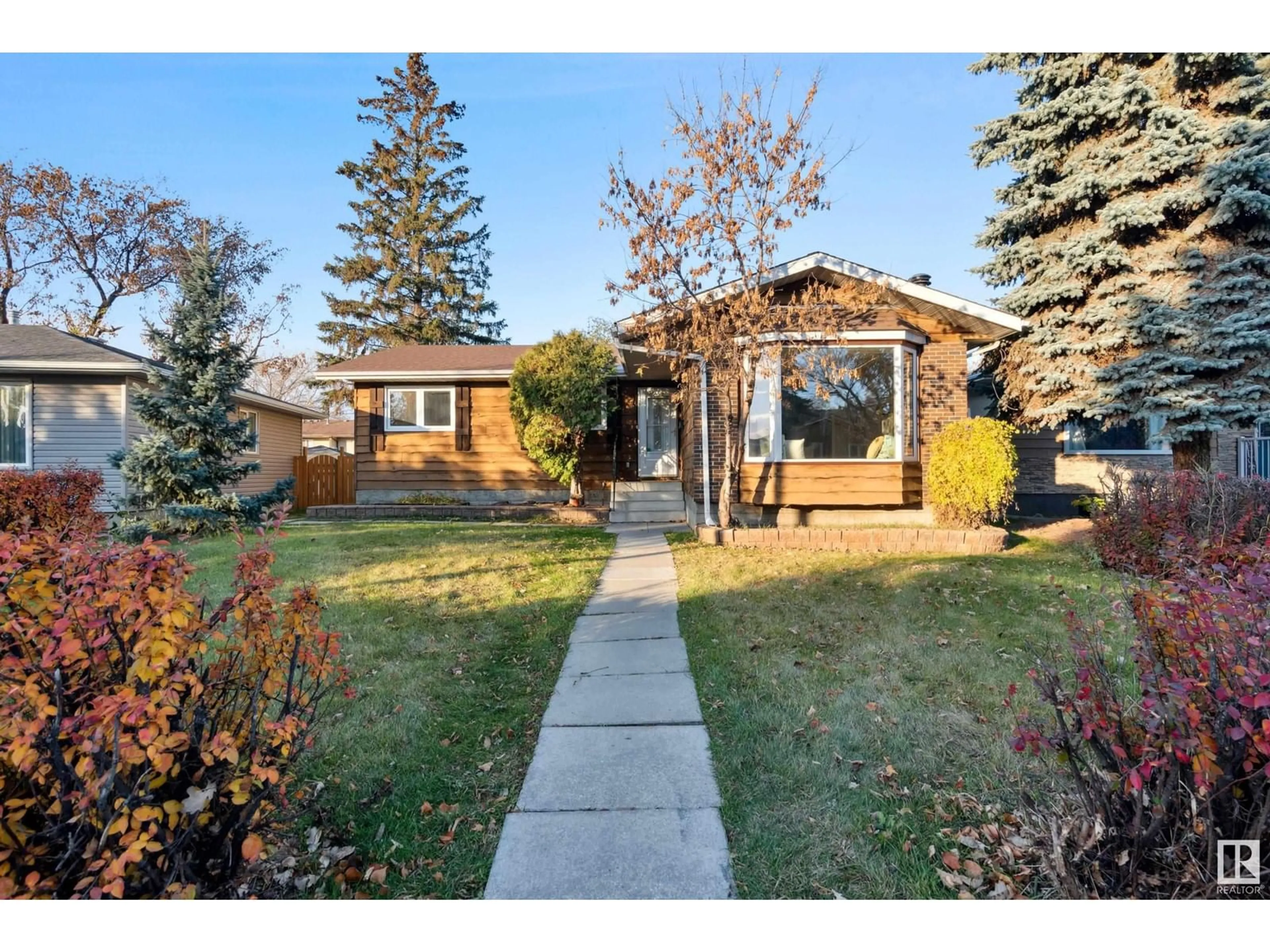 A pic from exterior of the house or condo, the fenced backyard for 2924 68 ST NW, Edmonton Alberta T6K1N6