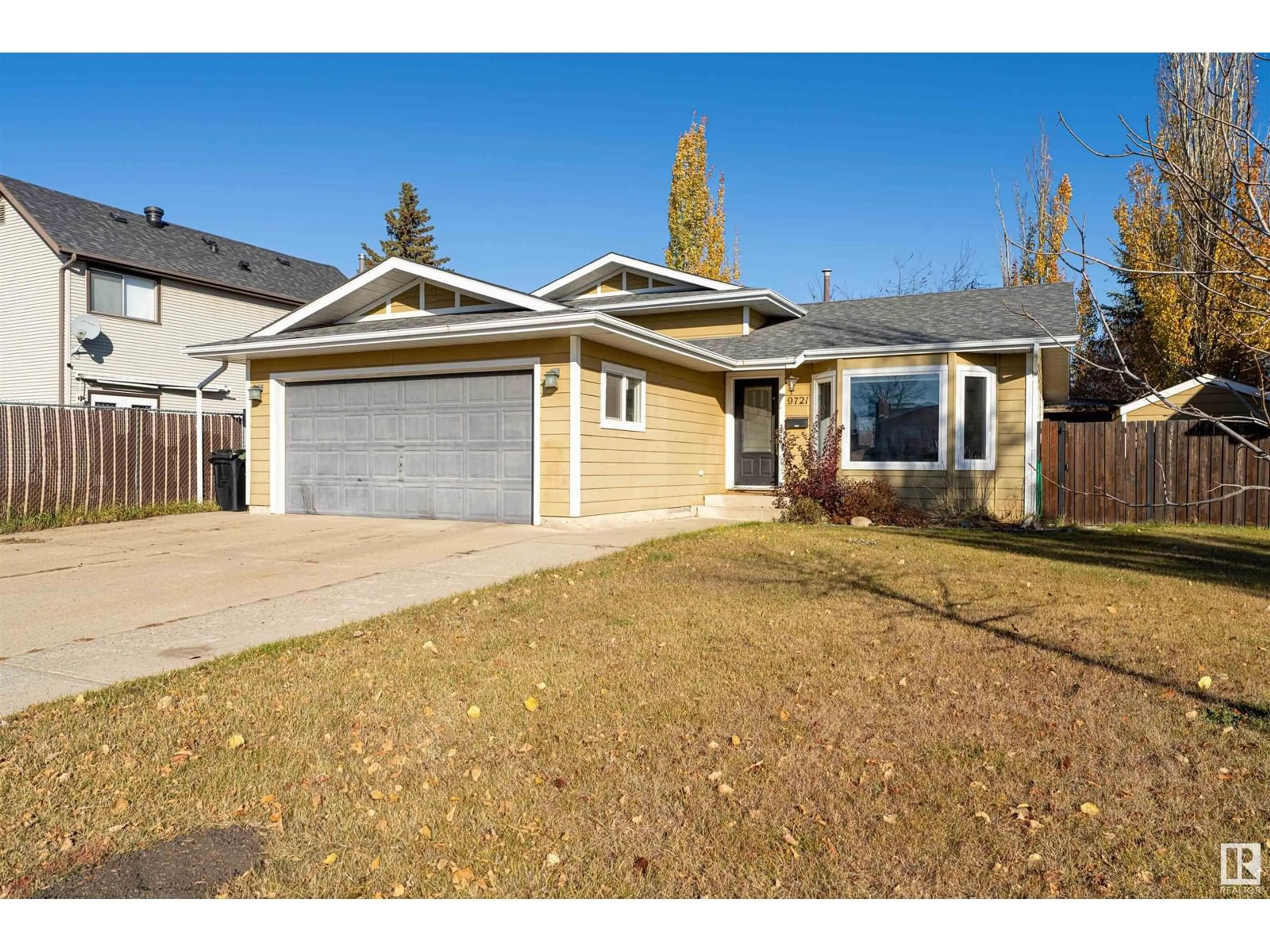 Frontside or backside of a home, the fenced backyard for 9721 85A ST, Fort Saskatchewan Alberta T8L2Z1