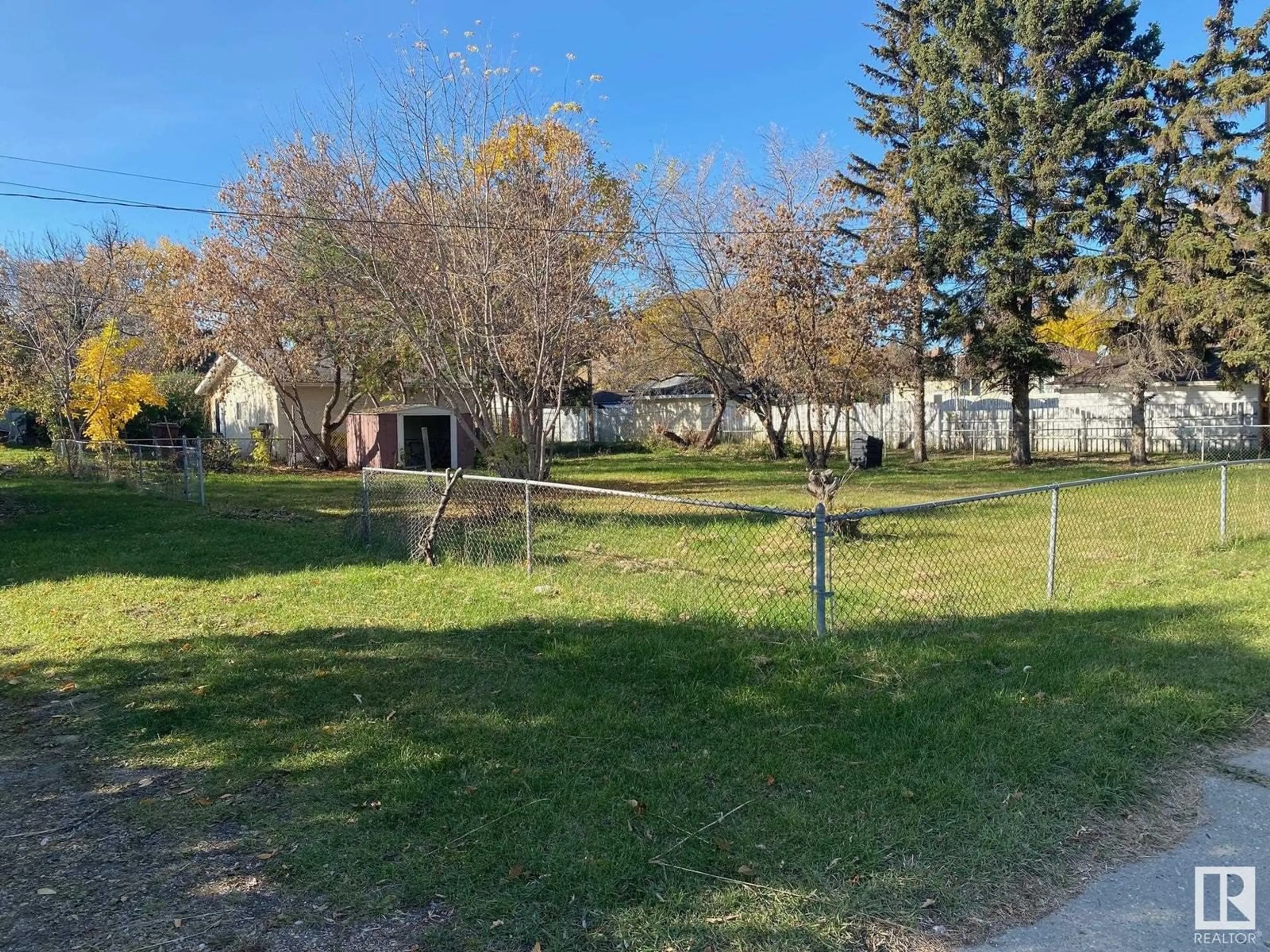 Frontside or backside of a home, the fenced backyard for 5314 45 AV, Wetaskiwin Alberta T9A0E8