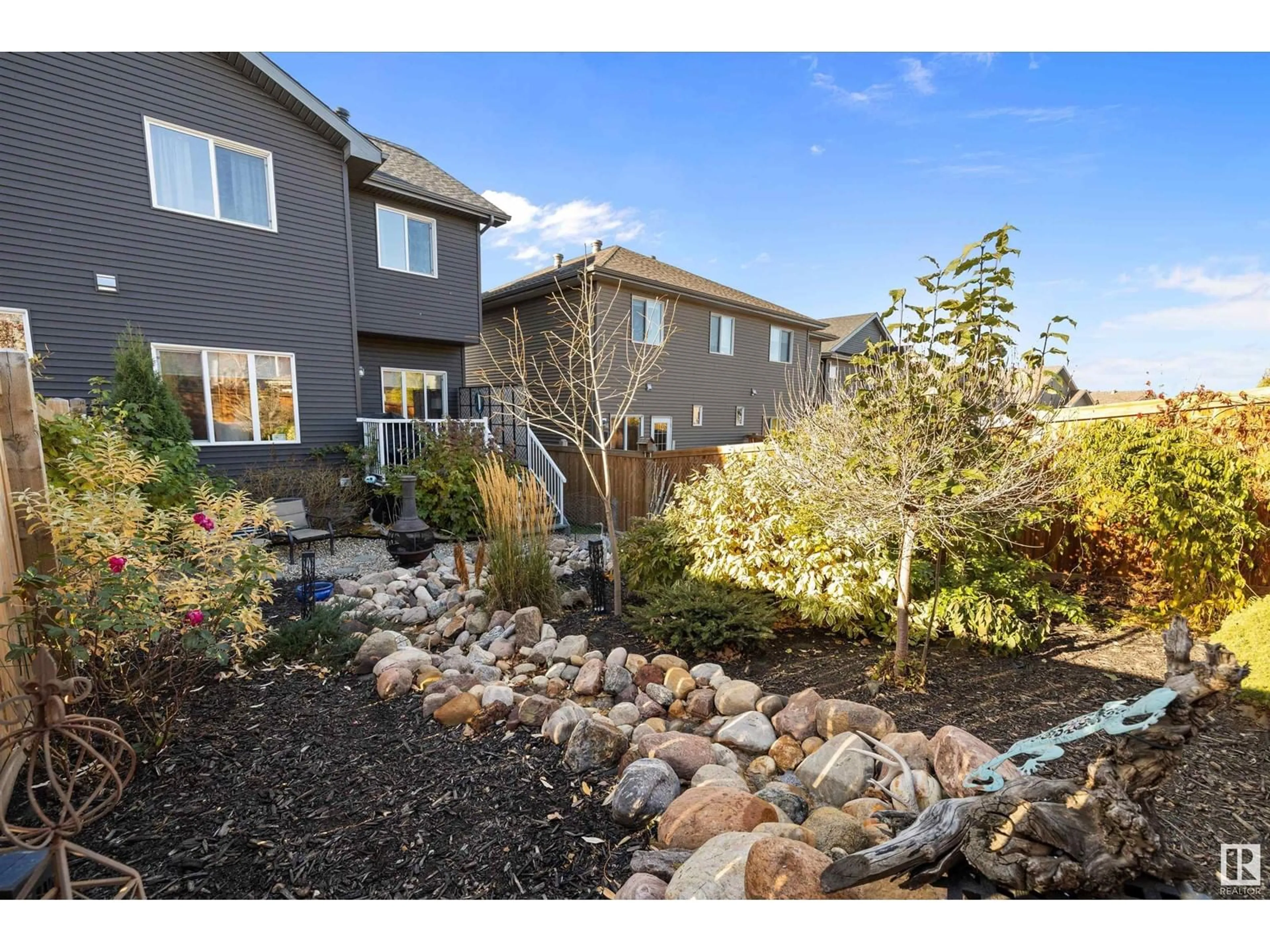 Frontside or backside of a home, the fenced backyard for 234 Hawks Ridge BV NW NW, Edmonton Alberta T5S0M1