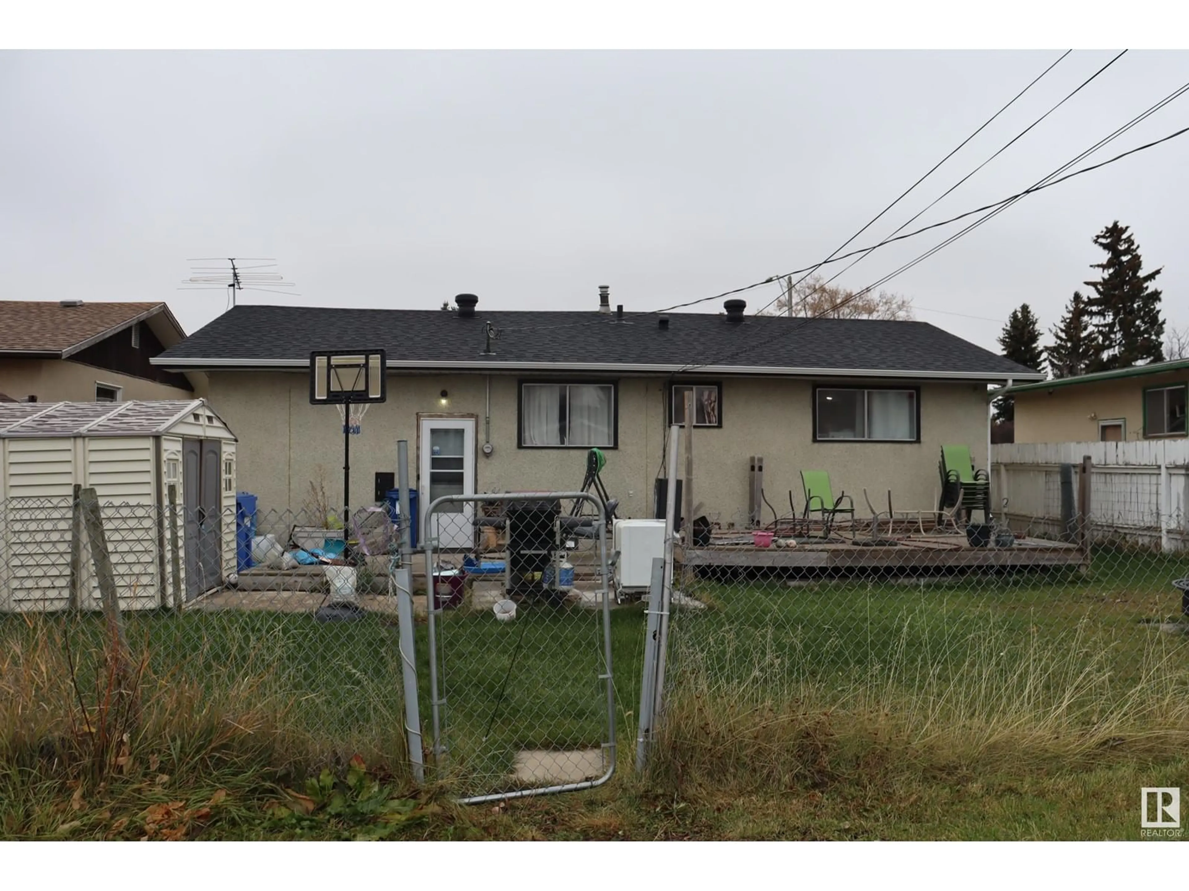 Frontside or backside of a home, the fenced backyard for 4616 45 Ave, Wetaskiwin Alberta T9A0E1