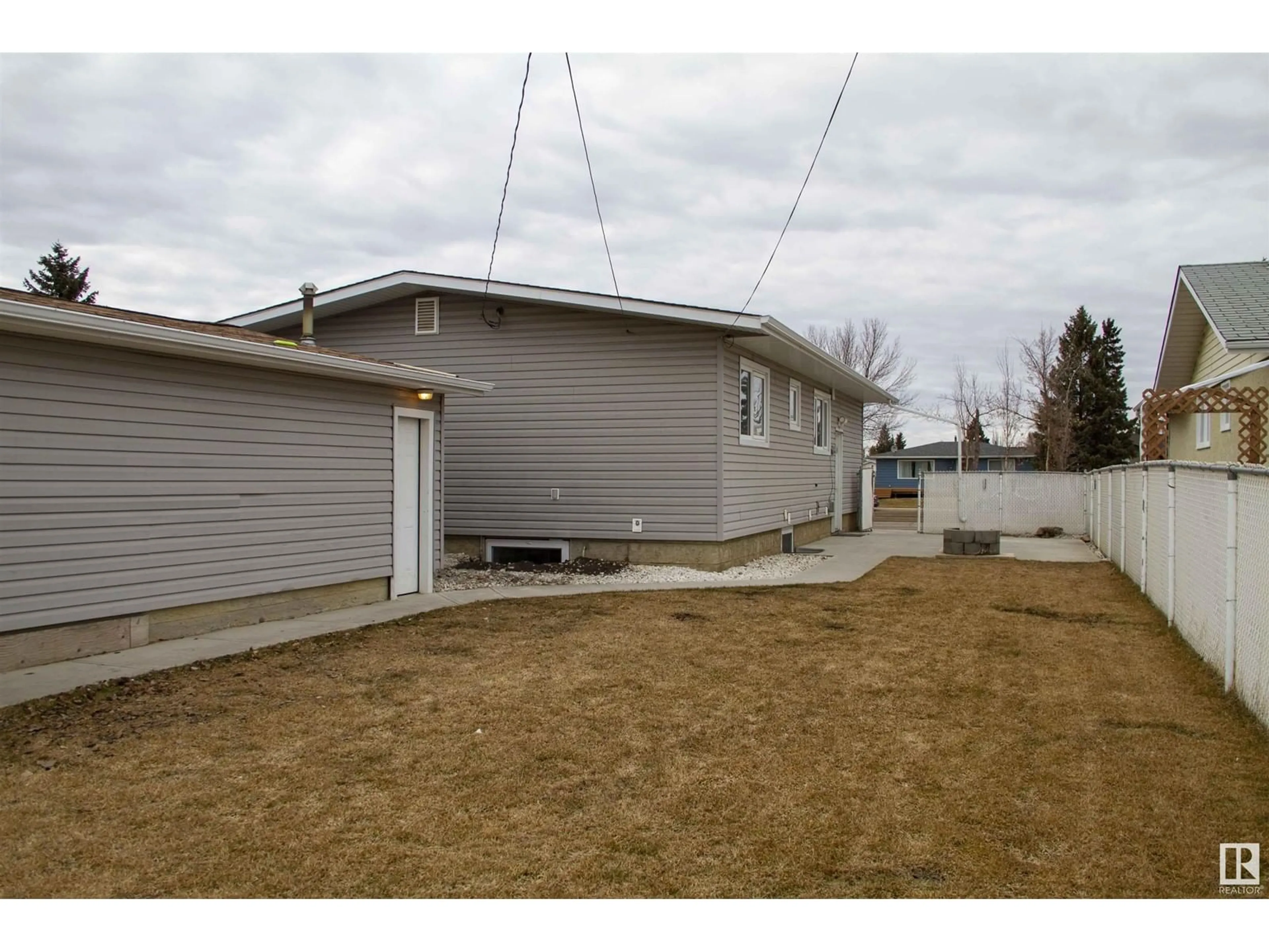 Frontside or backside of a home, the fenced backyard for 16805 95 AV NW, Edmonton Alberta T5P0B2