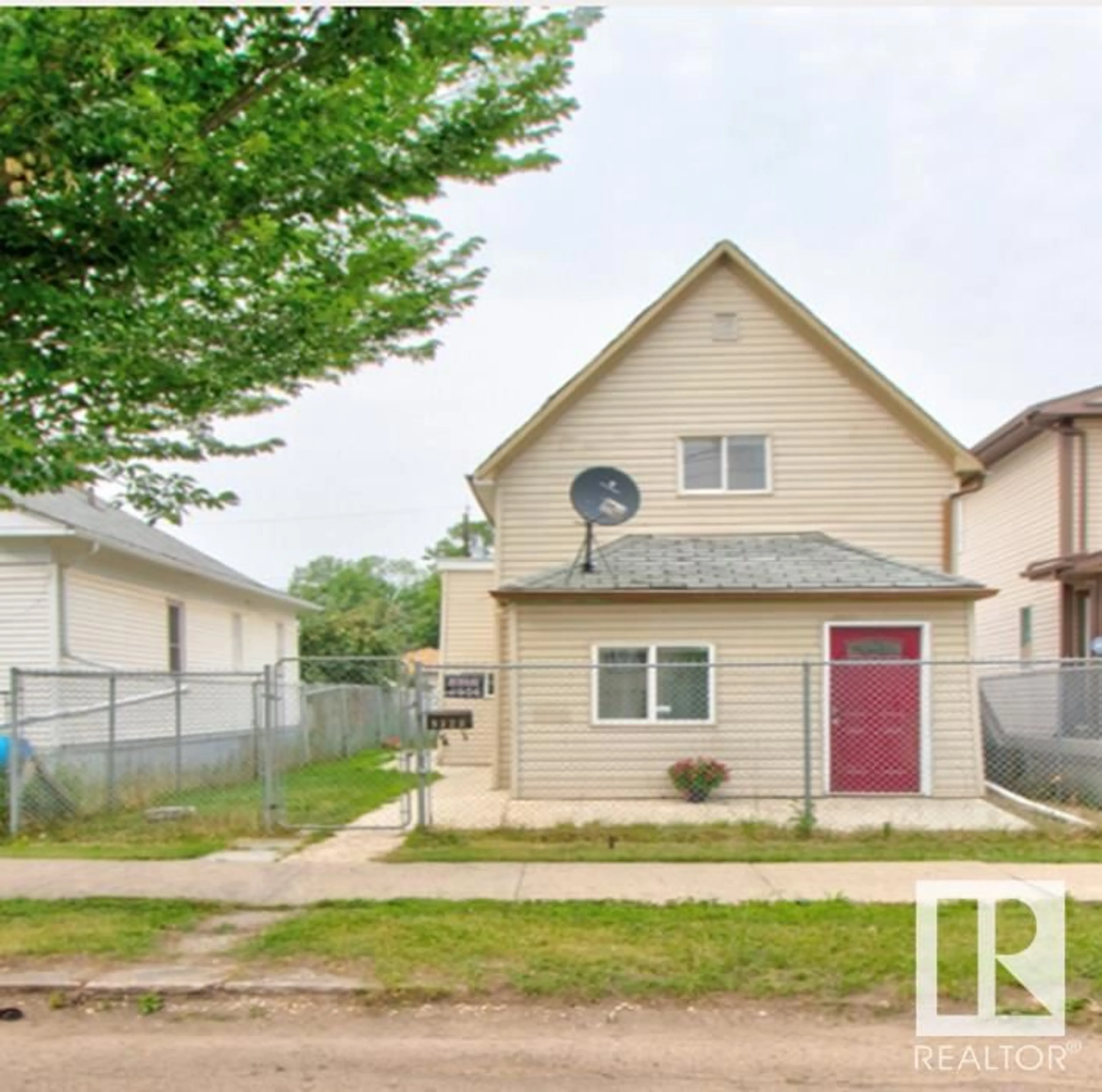 Frontside or backside of a home, the fenced backyard for 9328 106A AV NW, Edmonton Alberta T5H0S7