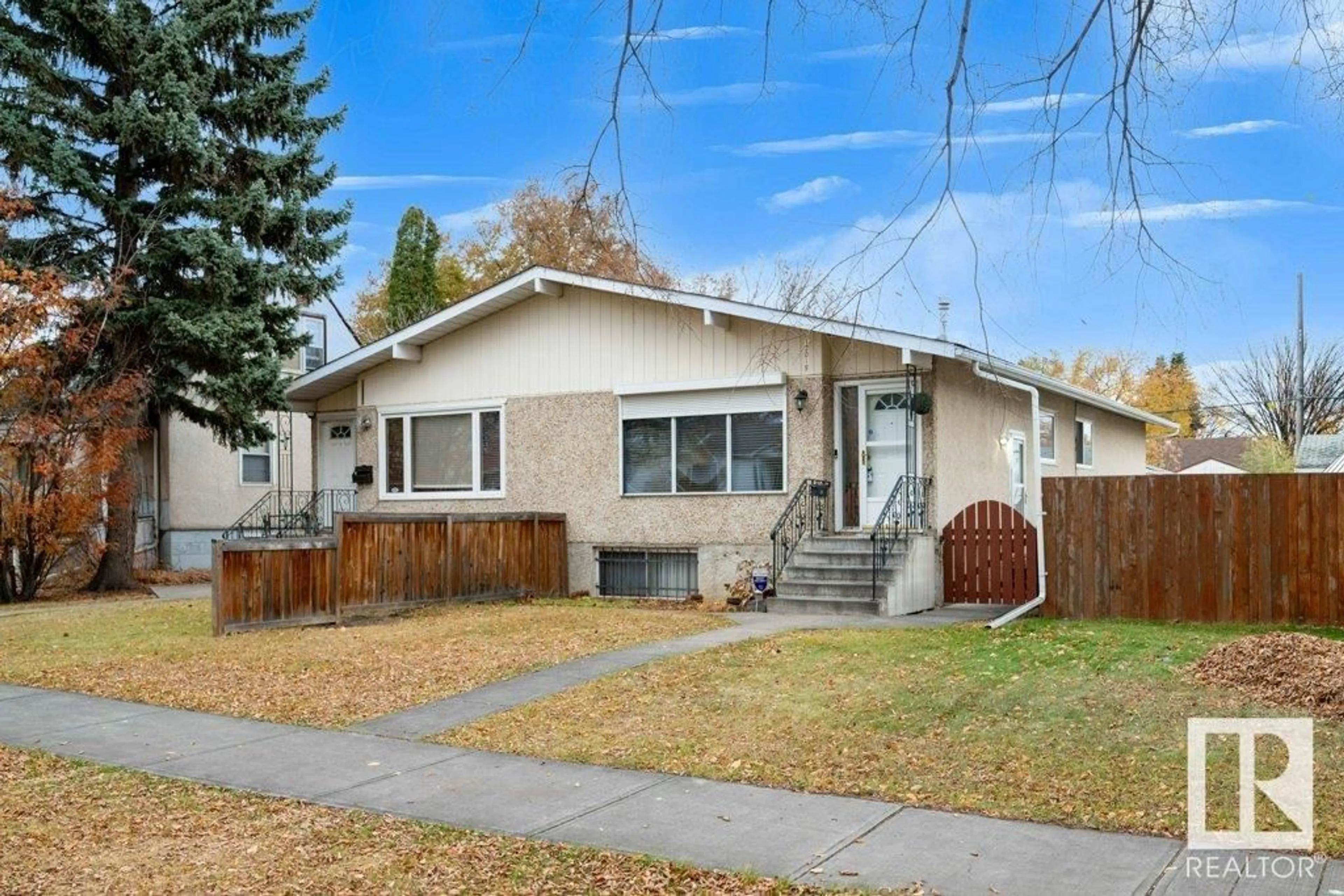 Frontside or backside of a home, the fenced backyard for 12019 104 ST NW, Edmonton Alberta T5G2L5