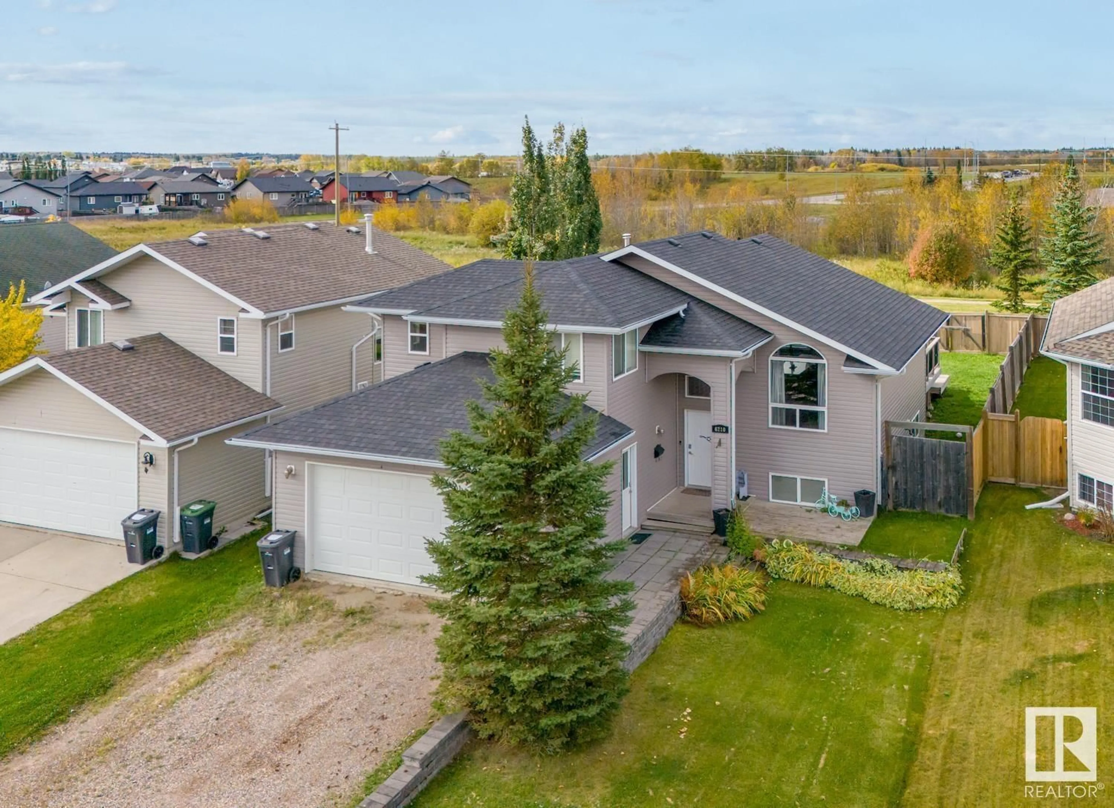 Frontside or backside of a home, the fenced backyard for 6210 48 ST, Cold Lake Alberta T9M2B6