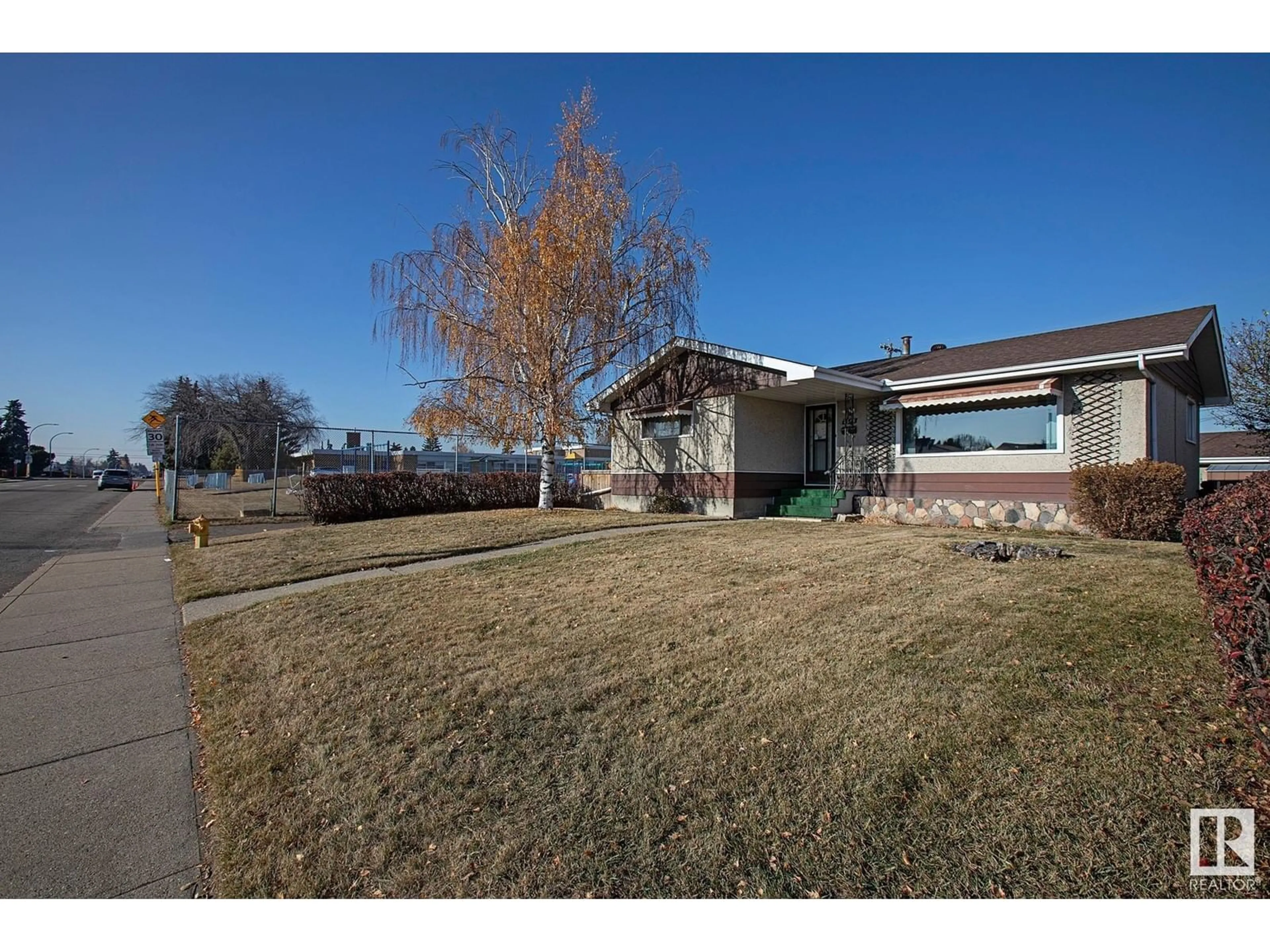 Frontside or backside of a home, the fenced backyard for 7616 130 AV NW, Edmonton Alberta T5C1Y2