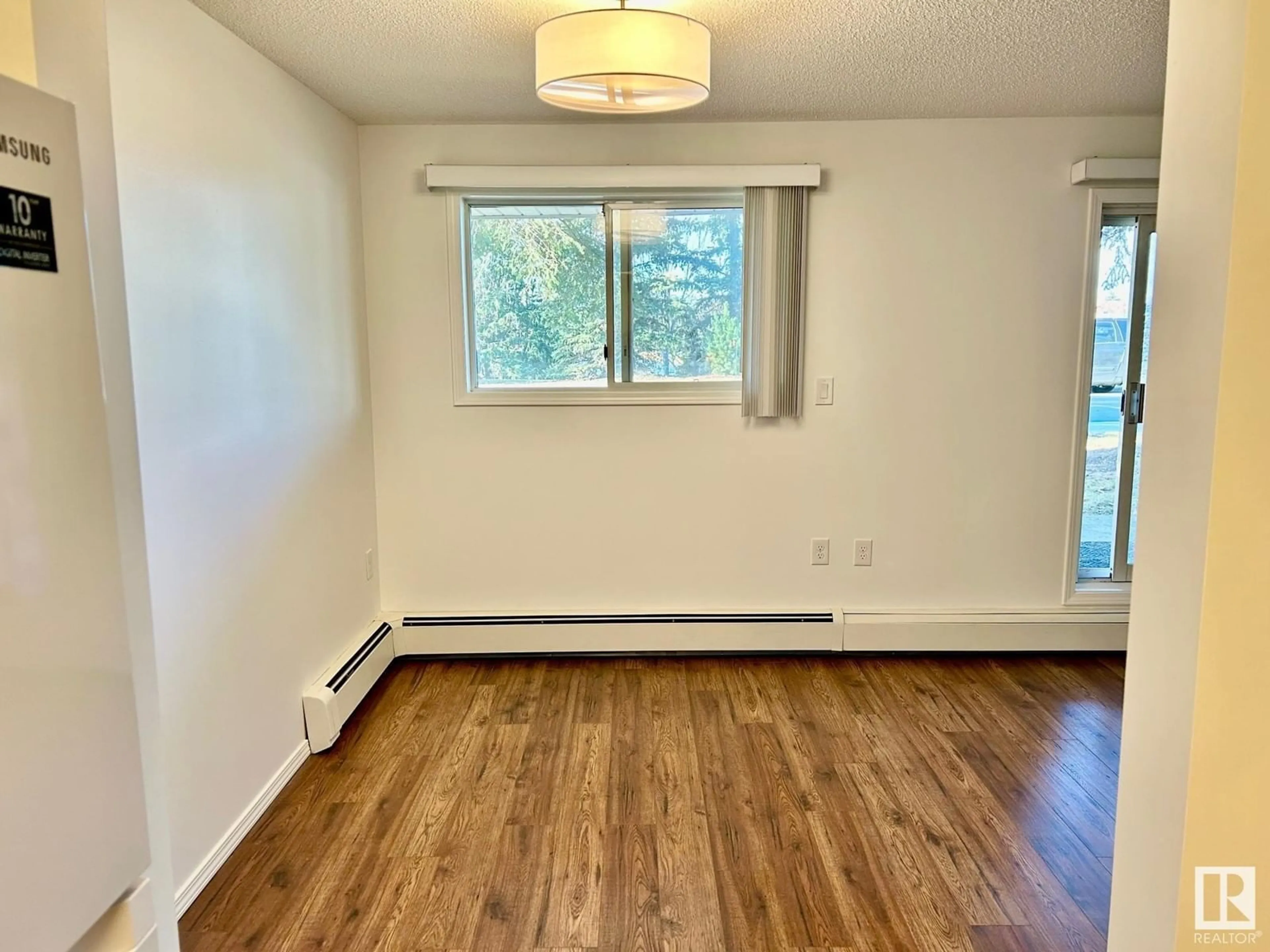 A pic of a room, wood floors for #112 15503 106 ST NW, Edmonton Alberta T5X5W7