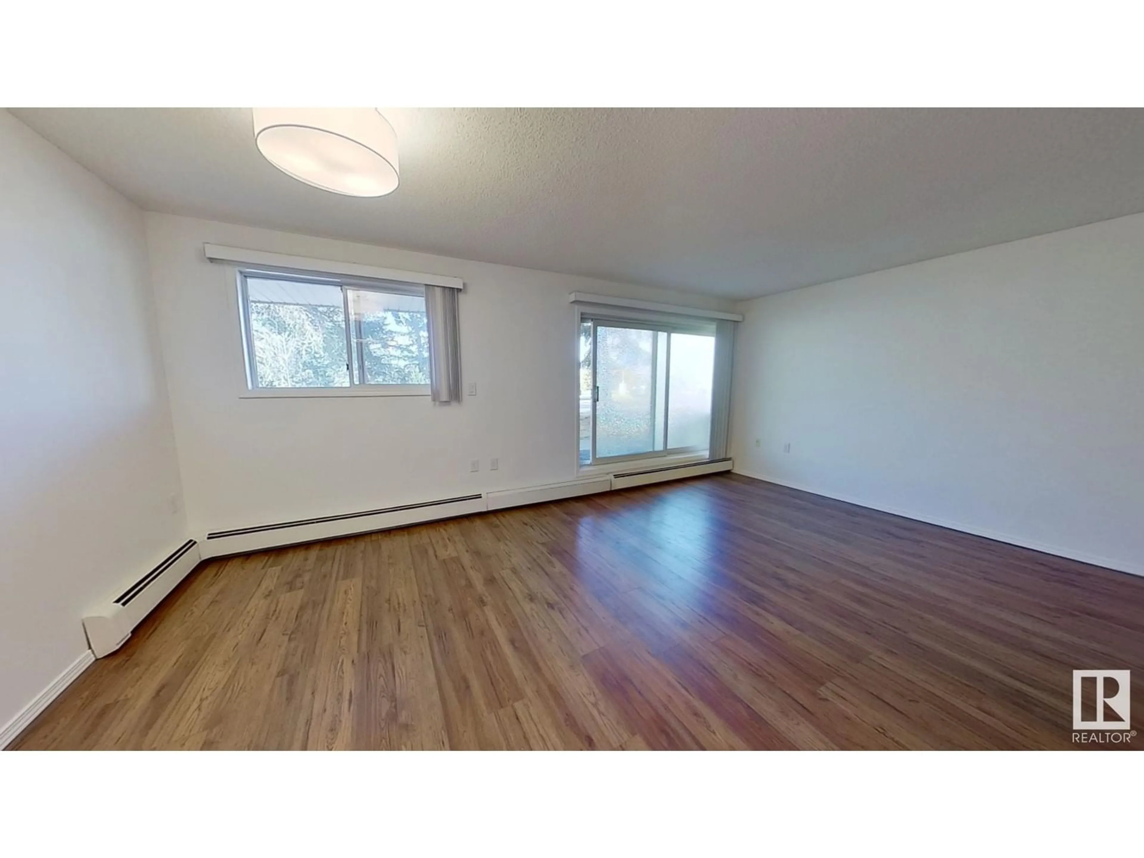 A pic of a room, wood floors for #112 15503 106 ST NW, Edmonton Alberta T5X5W7