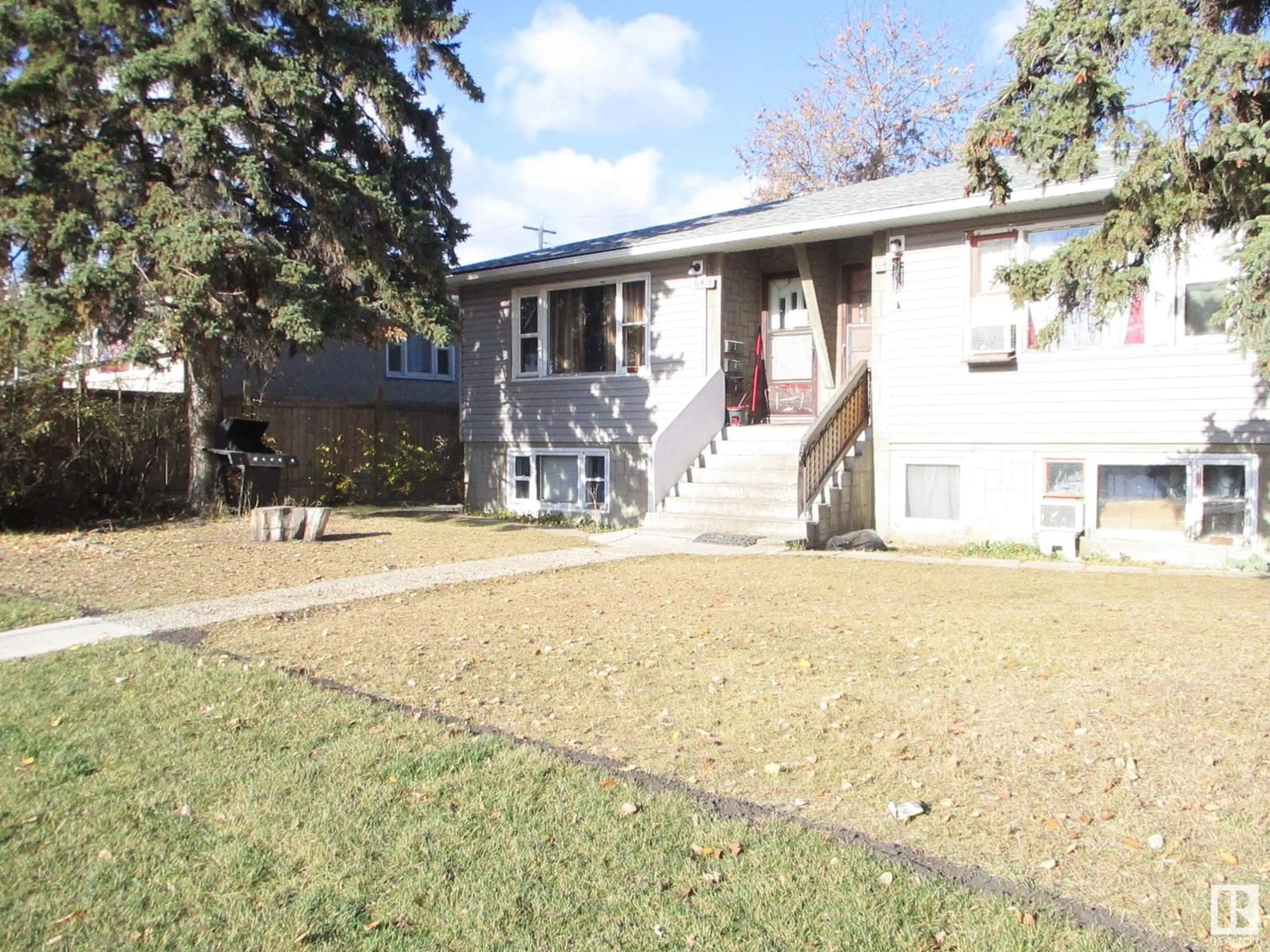 Frontside or backside of a home, the fenced backyard for 6418 132 AV NW NW, Edmonton Alberta T5A0J8