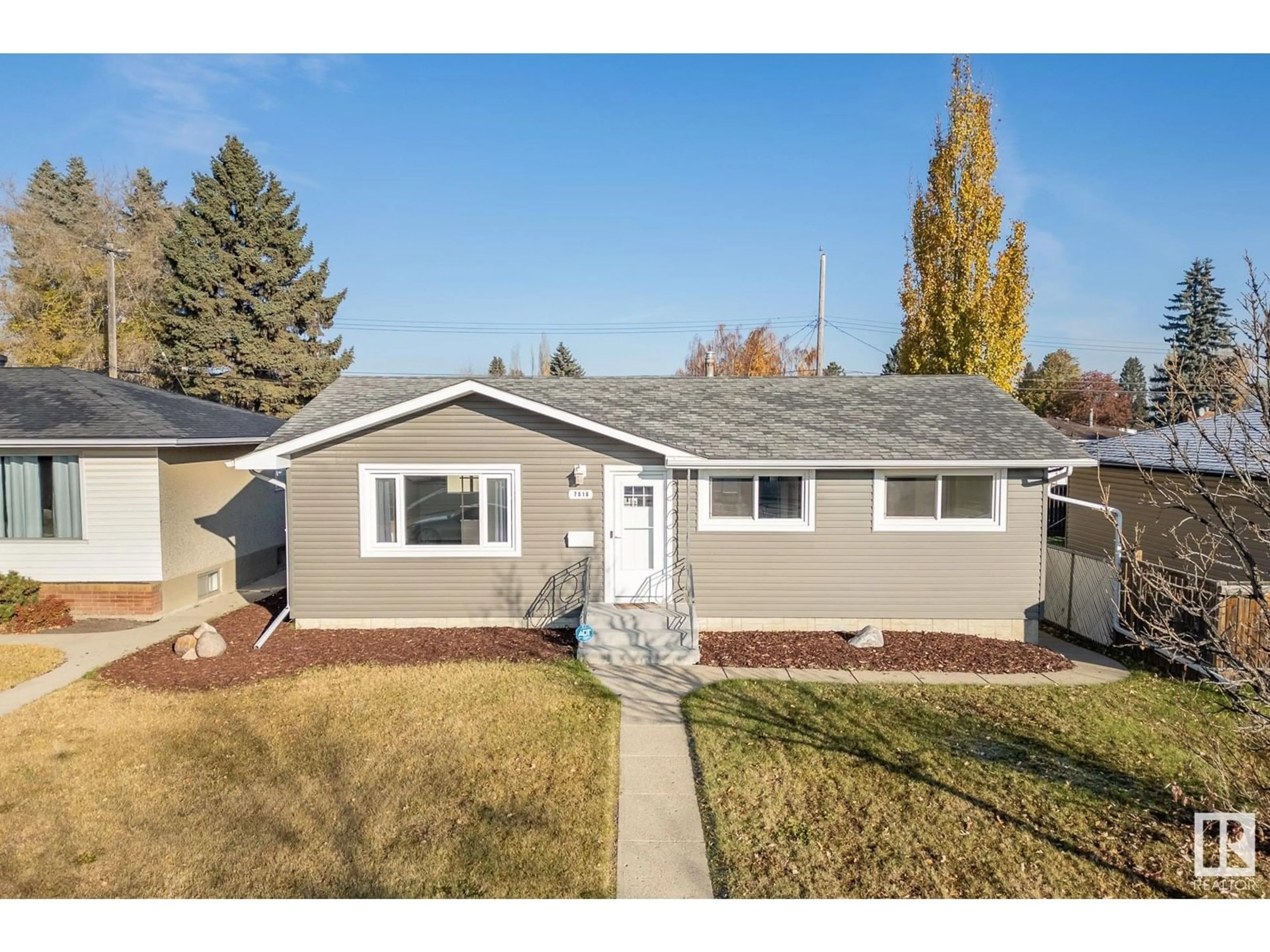 Frontside or backside of a home, the fenced backyard for 7016 90 AV NW, Edmonton Alberta T6B0P4