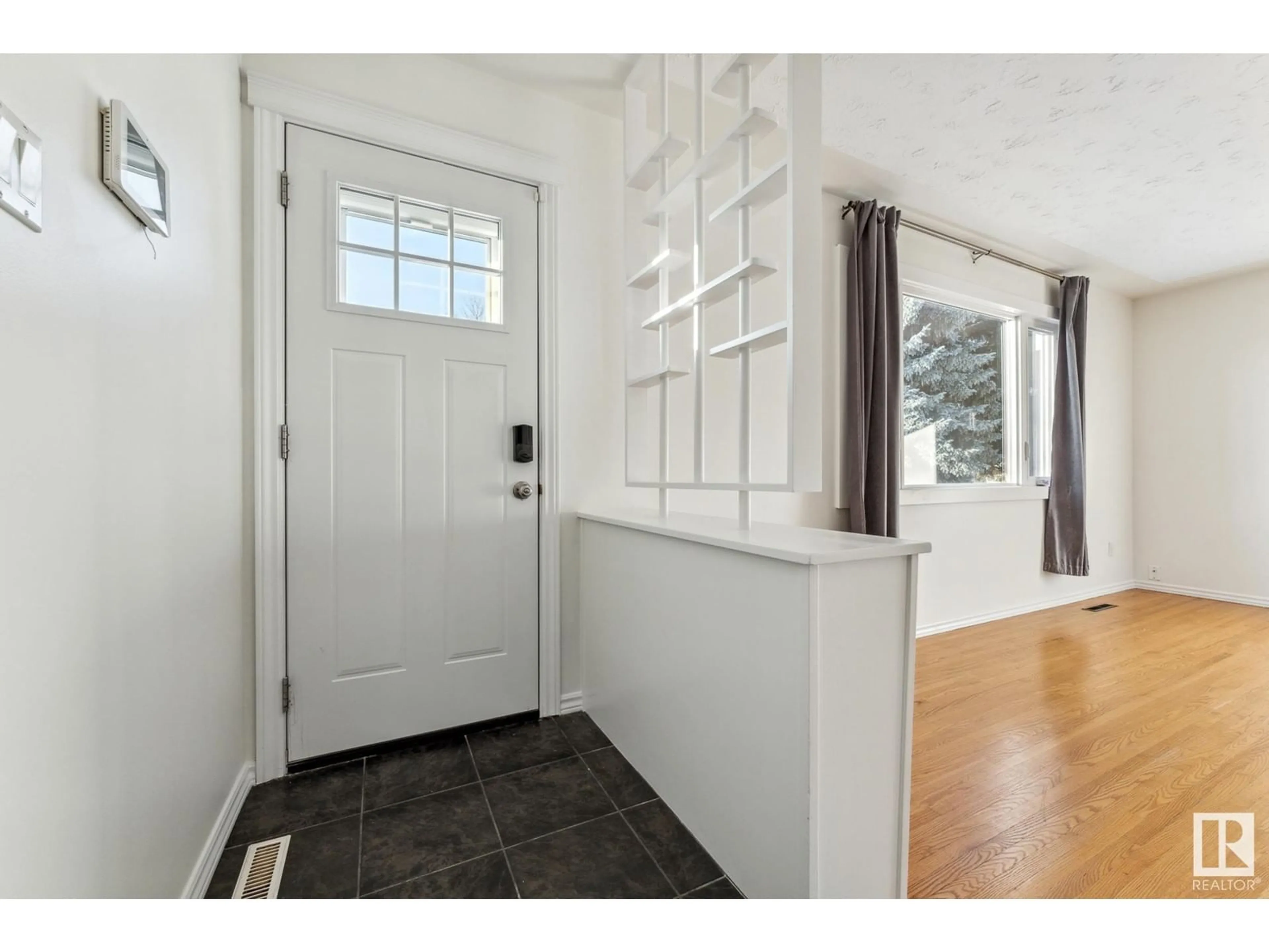 Indoor entryway, wood floors for 7016 90 AV NW, Edmonton Alberta T6B0P4