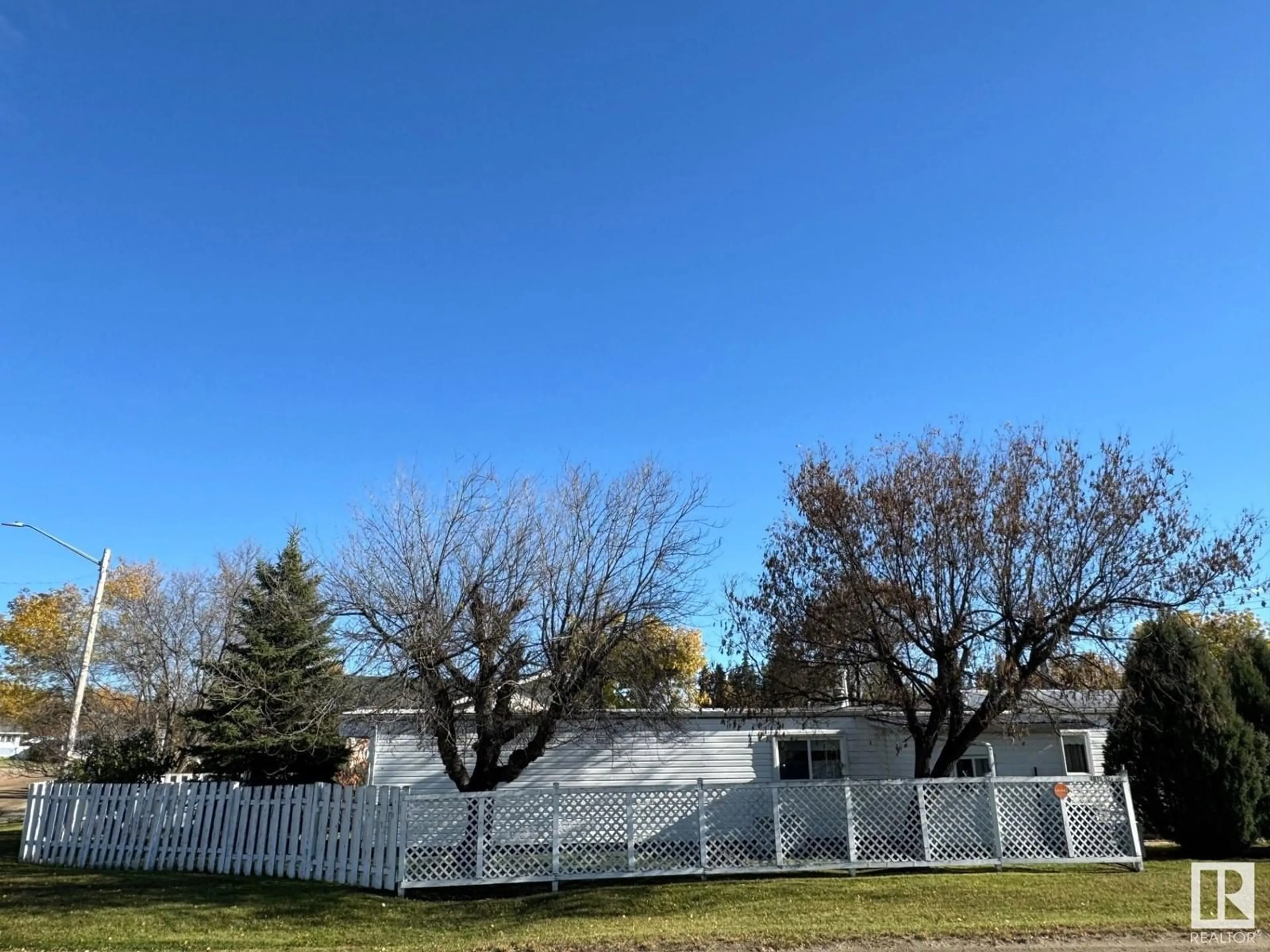 Frontside or backside of a home, the fenced backyard for 4815 52 A AV, Evansburg Alberta T0E0T0