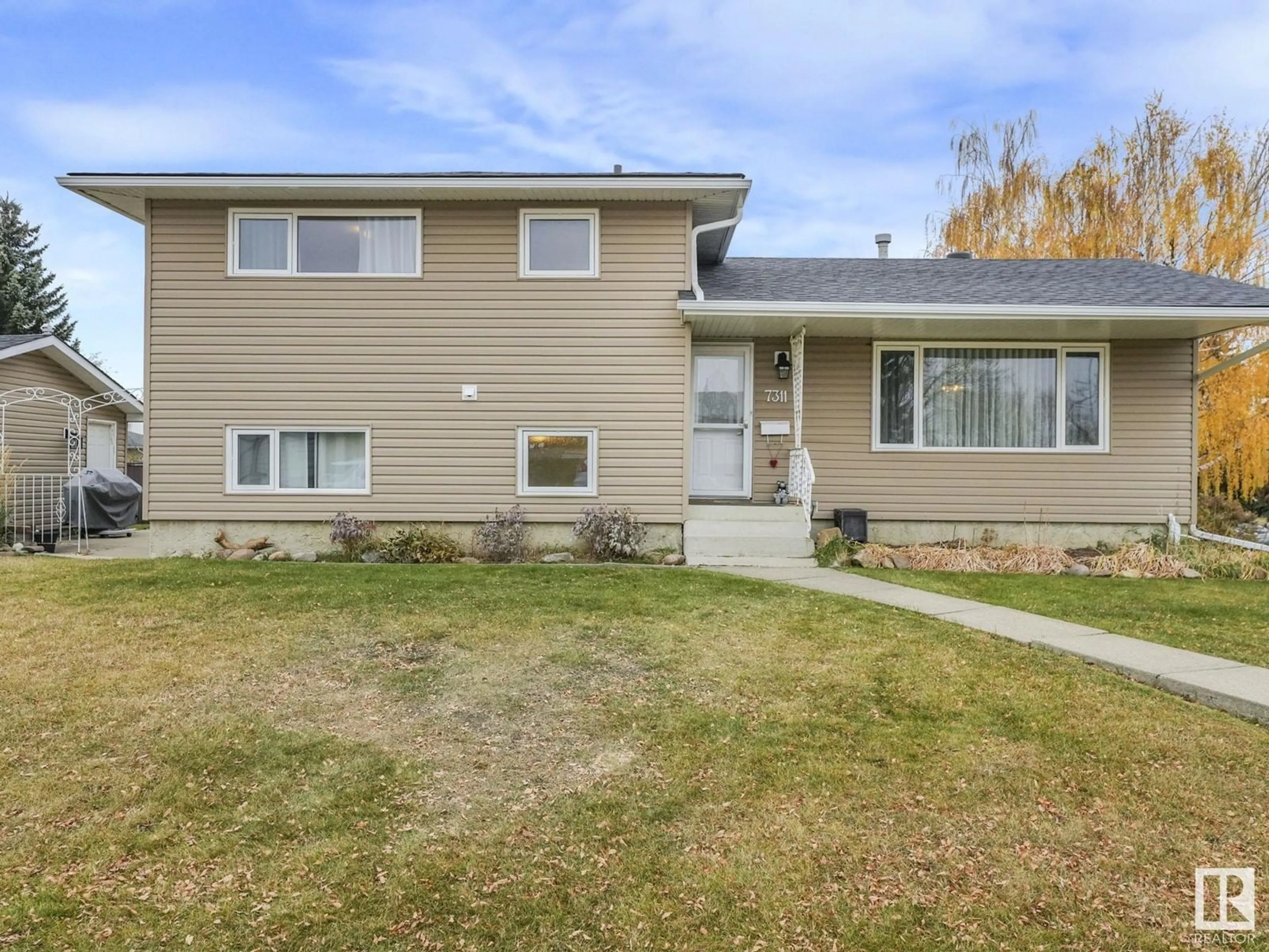 Frontside or backside of a home, the fenced backyard for 7311 143 AV NW NW, Edmonton Alberta T5C2P9