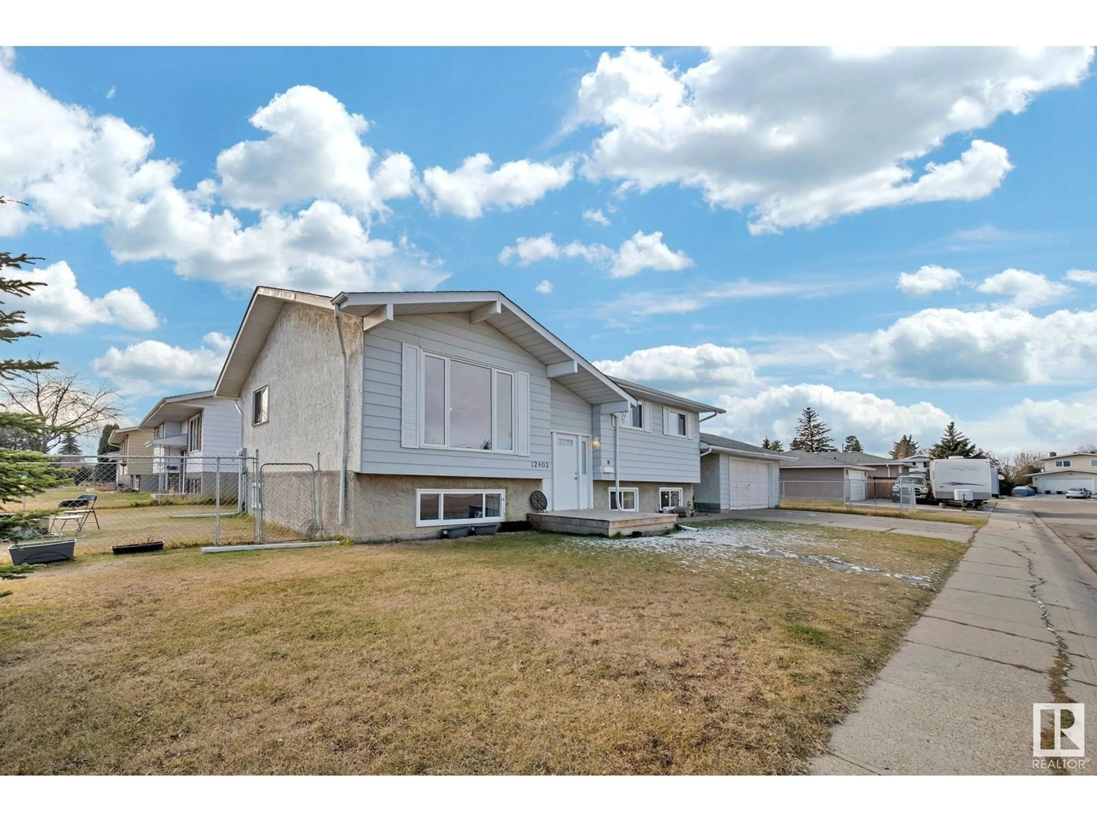 Frontside or backside of a home, the fenced backyard for 12403 159 AV NW, Edmonton Alberta T5X2Y4