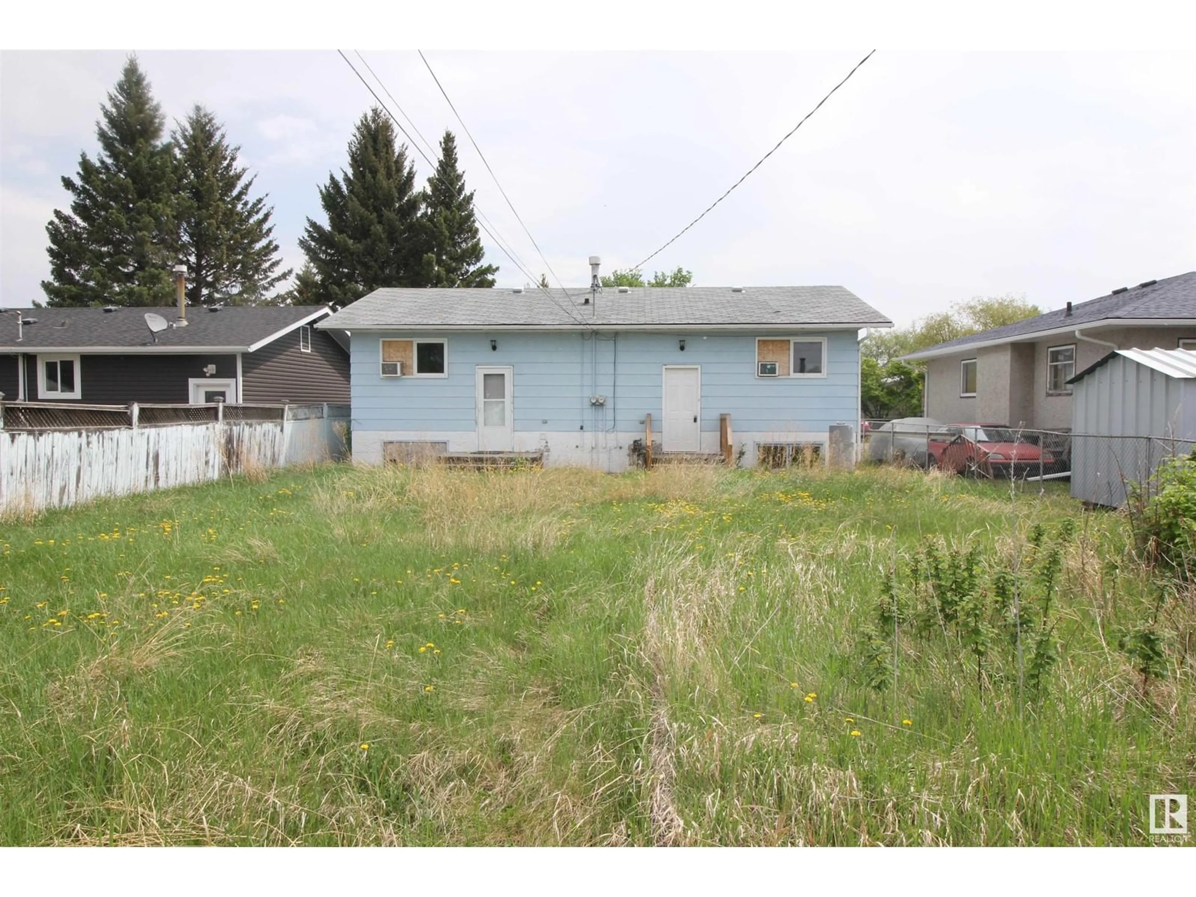 Frontside or backside of a home, the fenced backyard for 5110 46 ST, Mannville Alberta T0B2W0