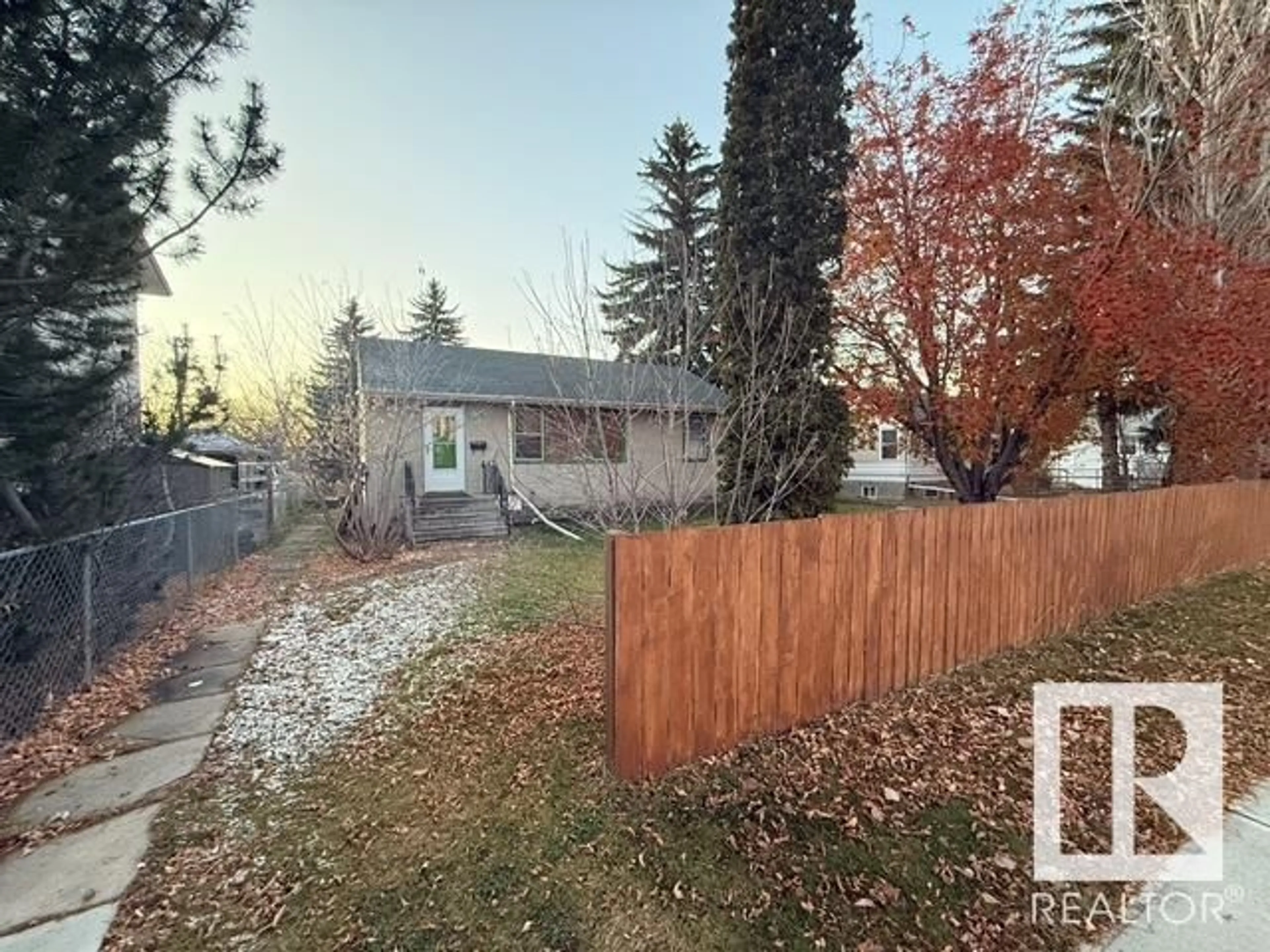 Frontside or backside of a home, the fenced backyard for 6316 105 ST NW, Edmonton Alberta T6H2N7