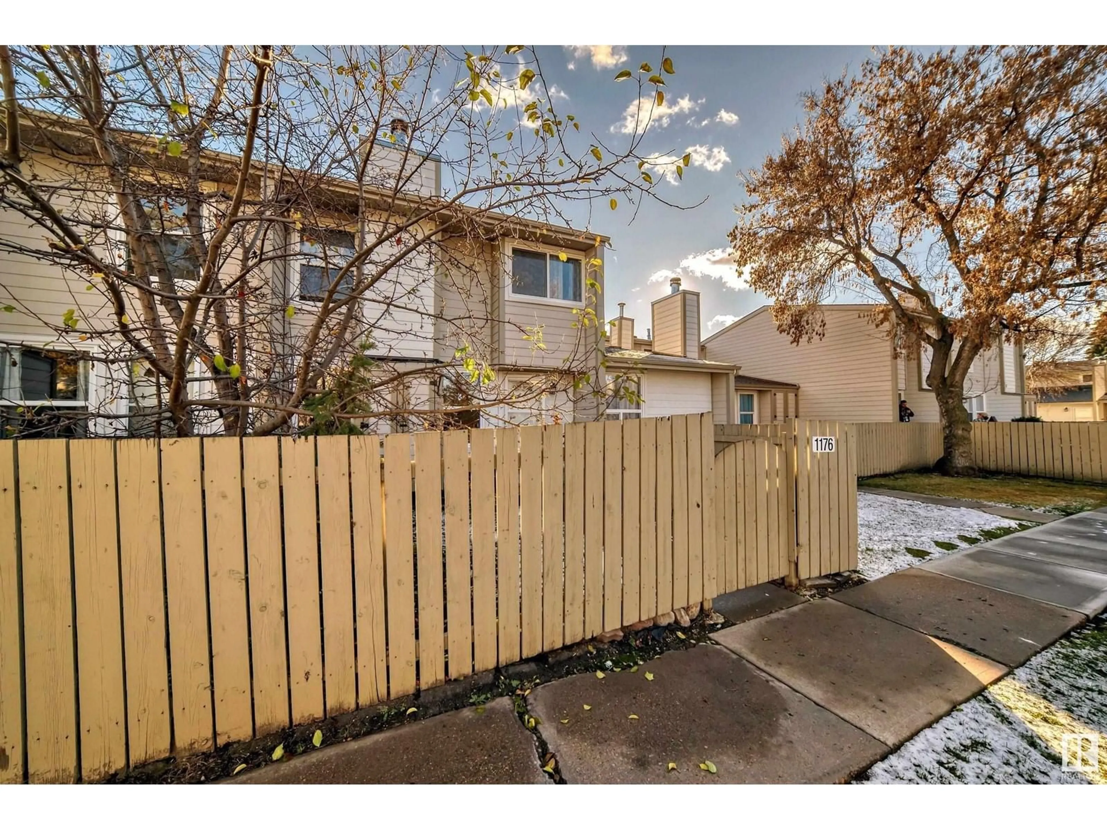 A pic from exterior of the house or condo, the fenced backyard for 1176 KNOTTWOOD RD E NW, Edmonton Alberta T6K2J8