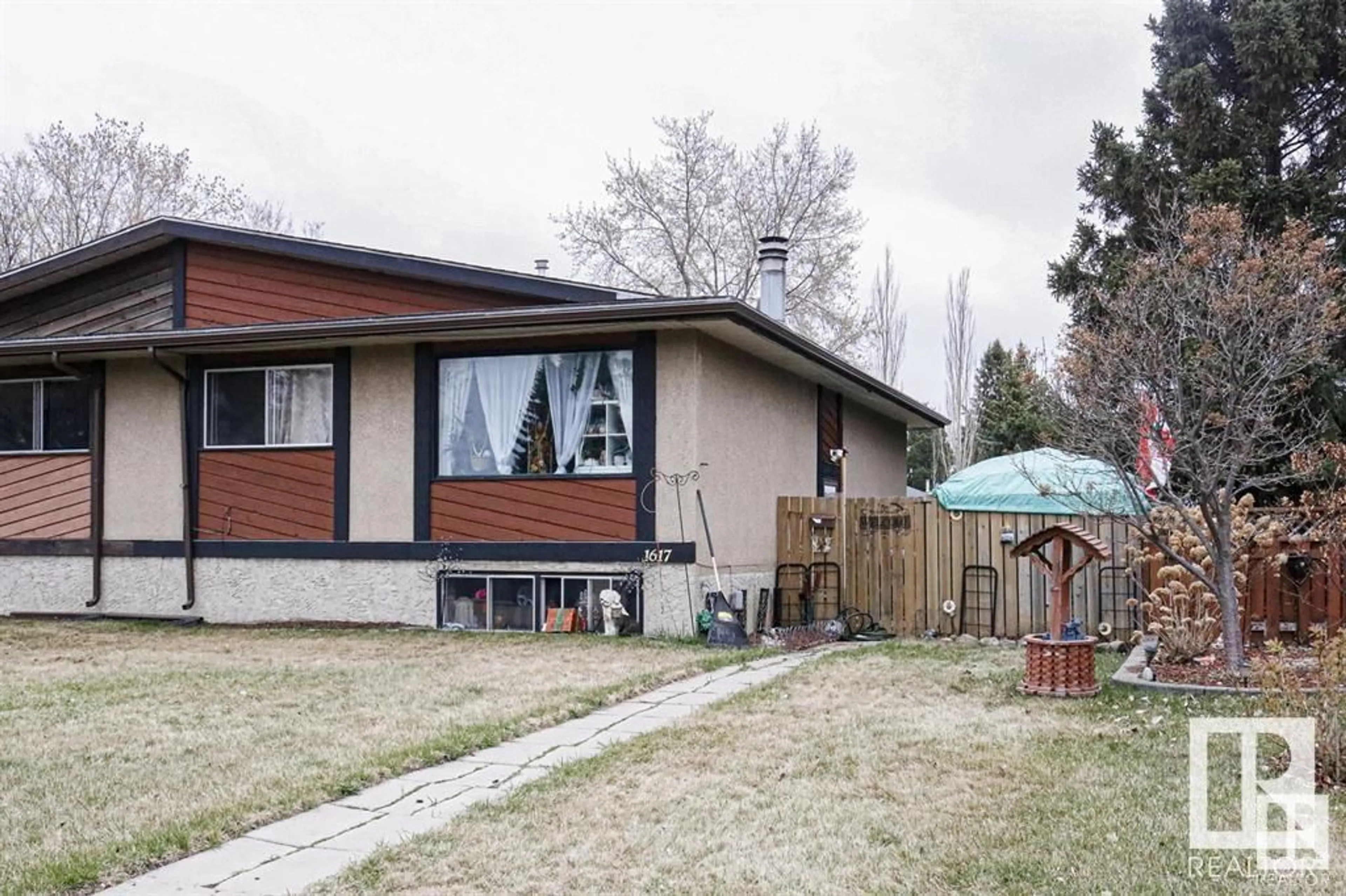 Frontside or backside of a home, the fenced backyard for 1617 Knottwood RD NW NW, Edmonton Alberta T6K2N3