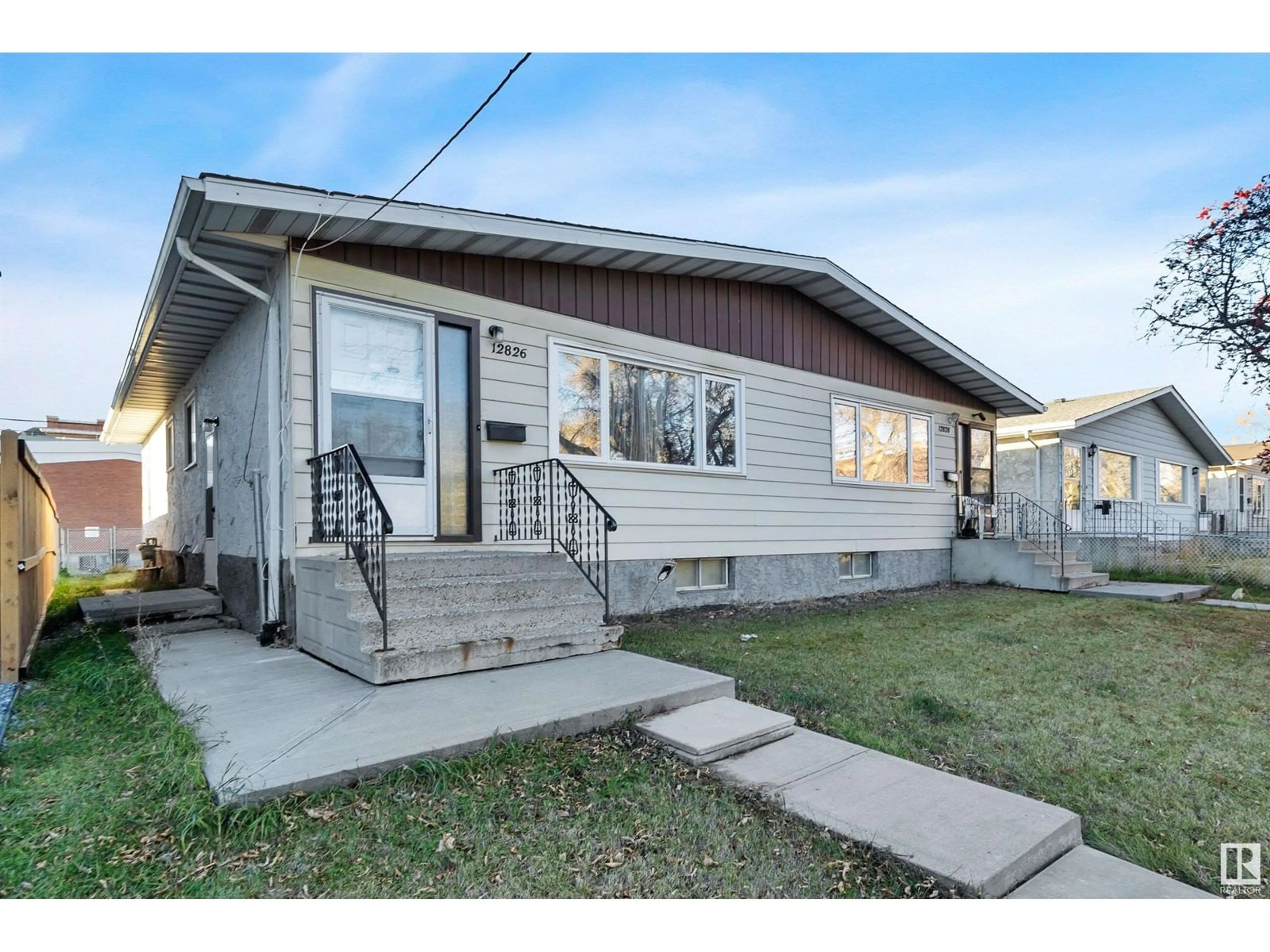 Frontside or backside of a home, the fenced backyard for 12828 68 ST NW, Edmonton Alberta T5C0E7