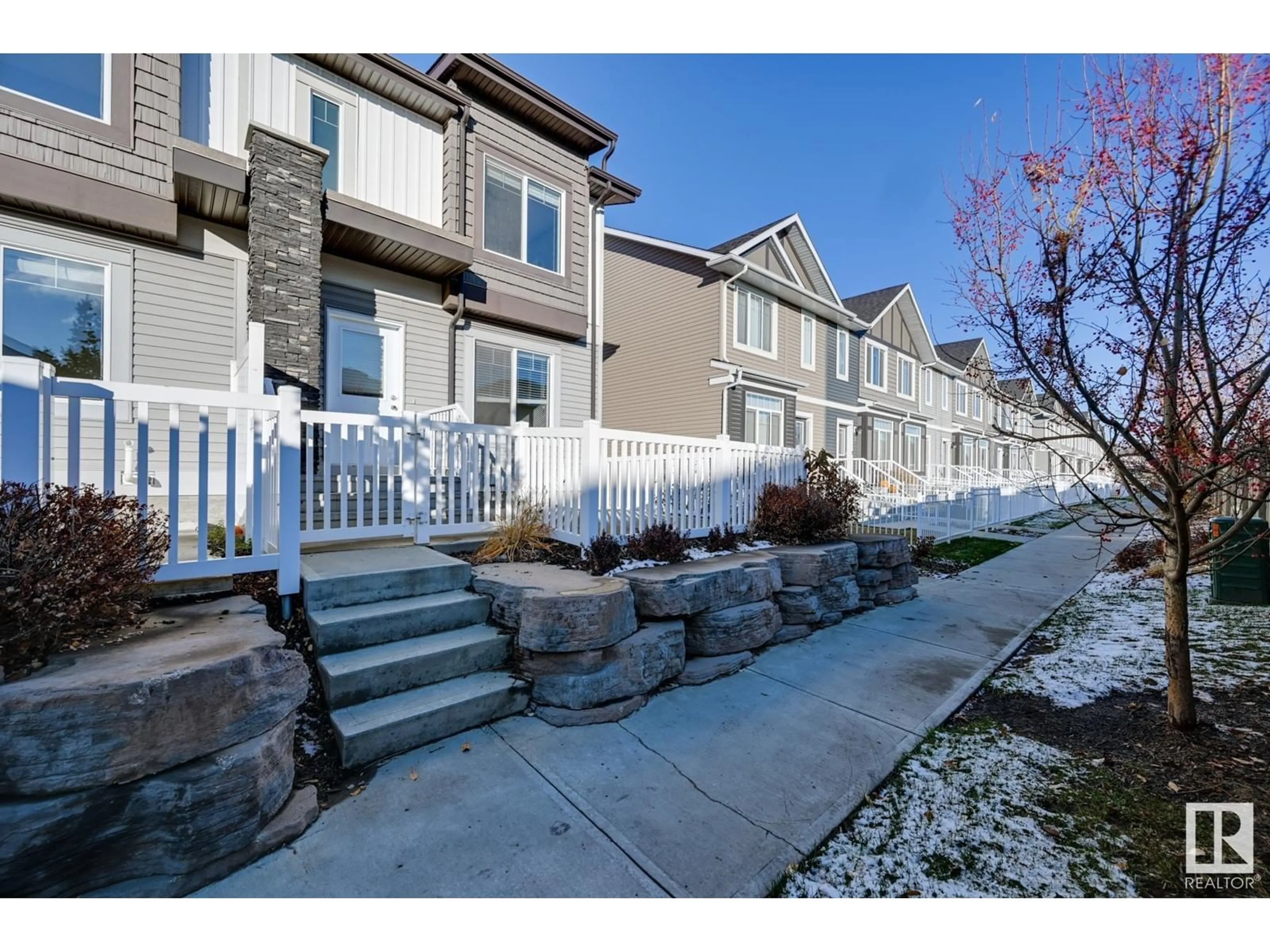 A pic from exterior of the house or condo, the fenced backyard for #7 2215 24 ST NW, Edmonton Alberta T6T1A6