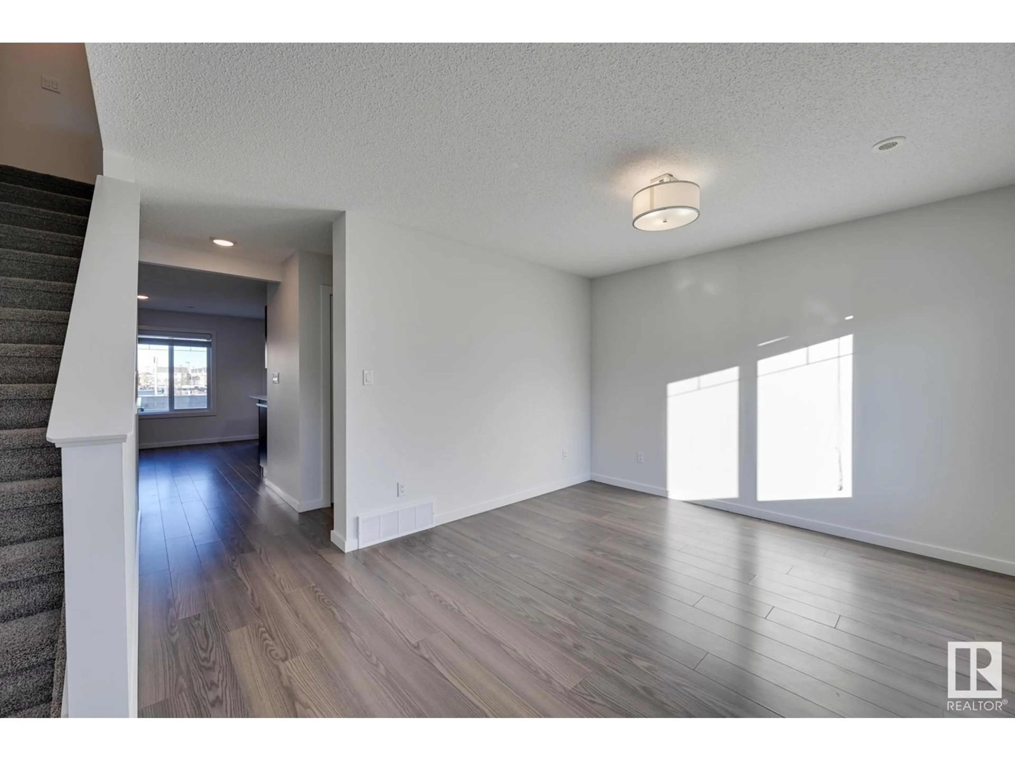 A pic of a room, wood floors for #7 2215 24 ST NW, Edmonton Alberta T6T1A6