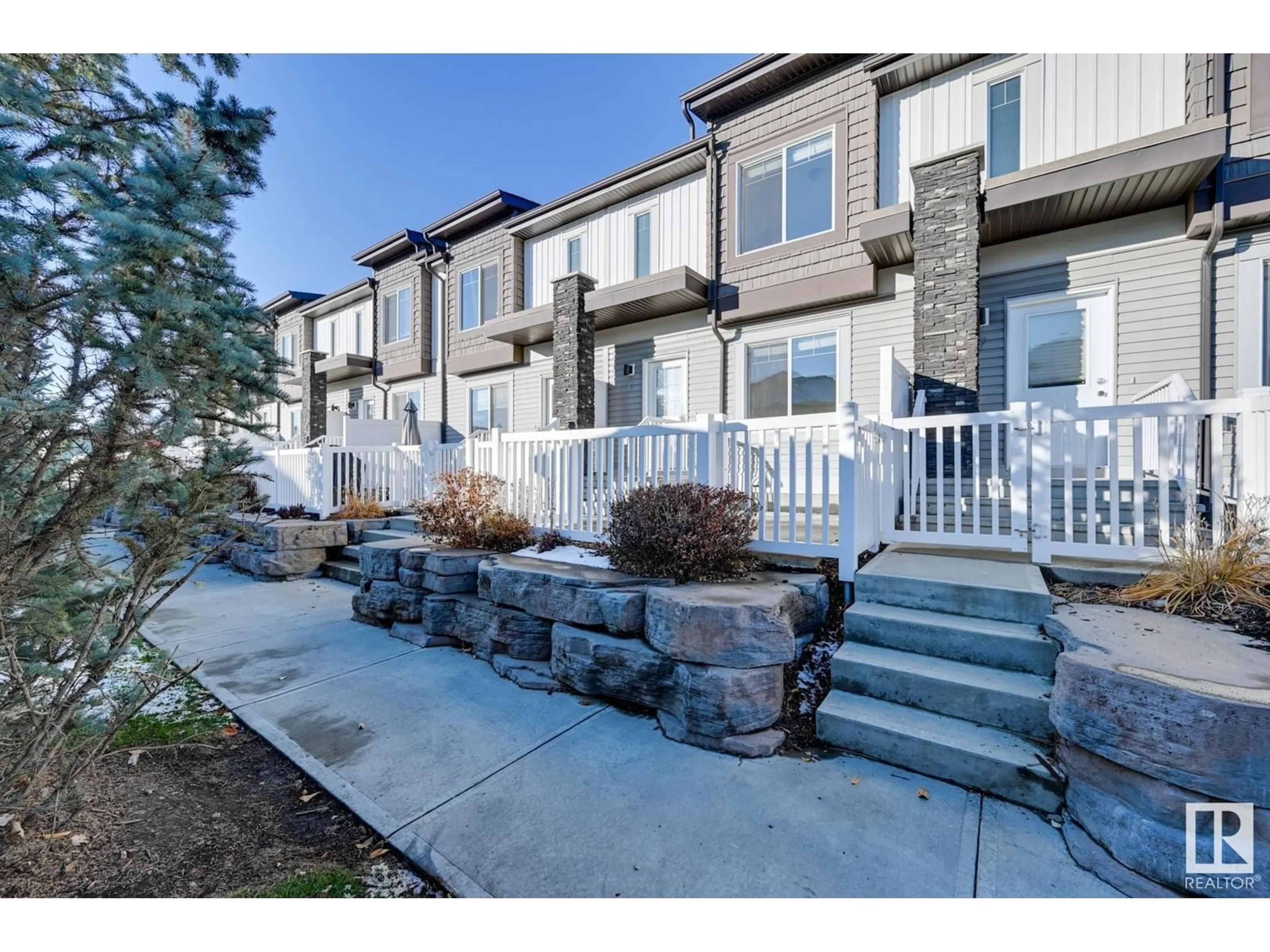 A pic from exterior of the house or condo, the fenced backyard for #6 2215 24 ST NW, Edmonton Alberta T6T1A6