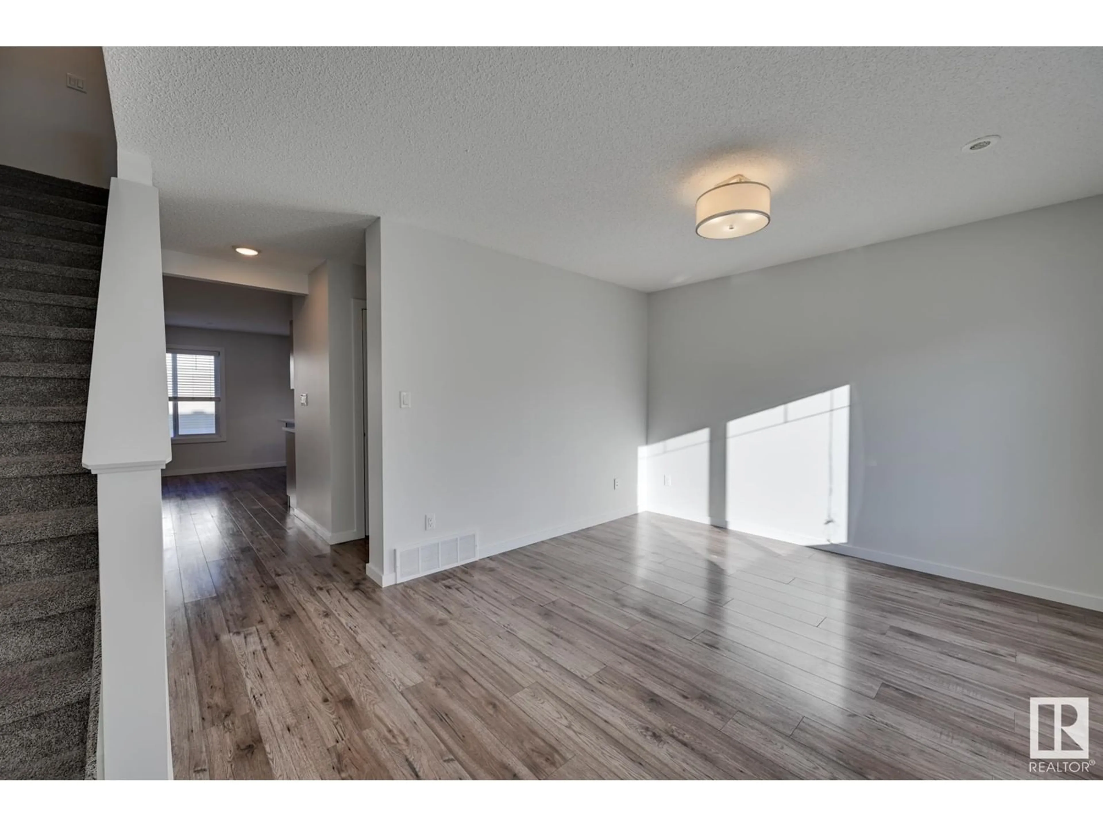 A pic of a room, wood floors for #6 2215 24 ST NW, Edmonton Alberta T6T1A6