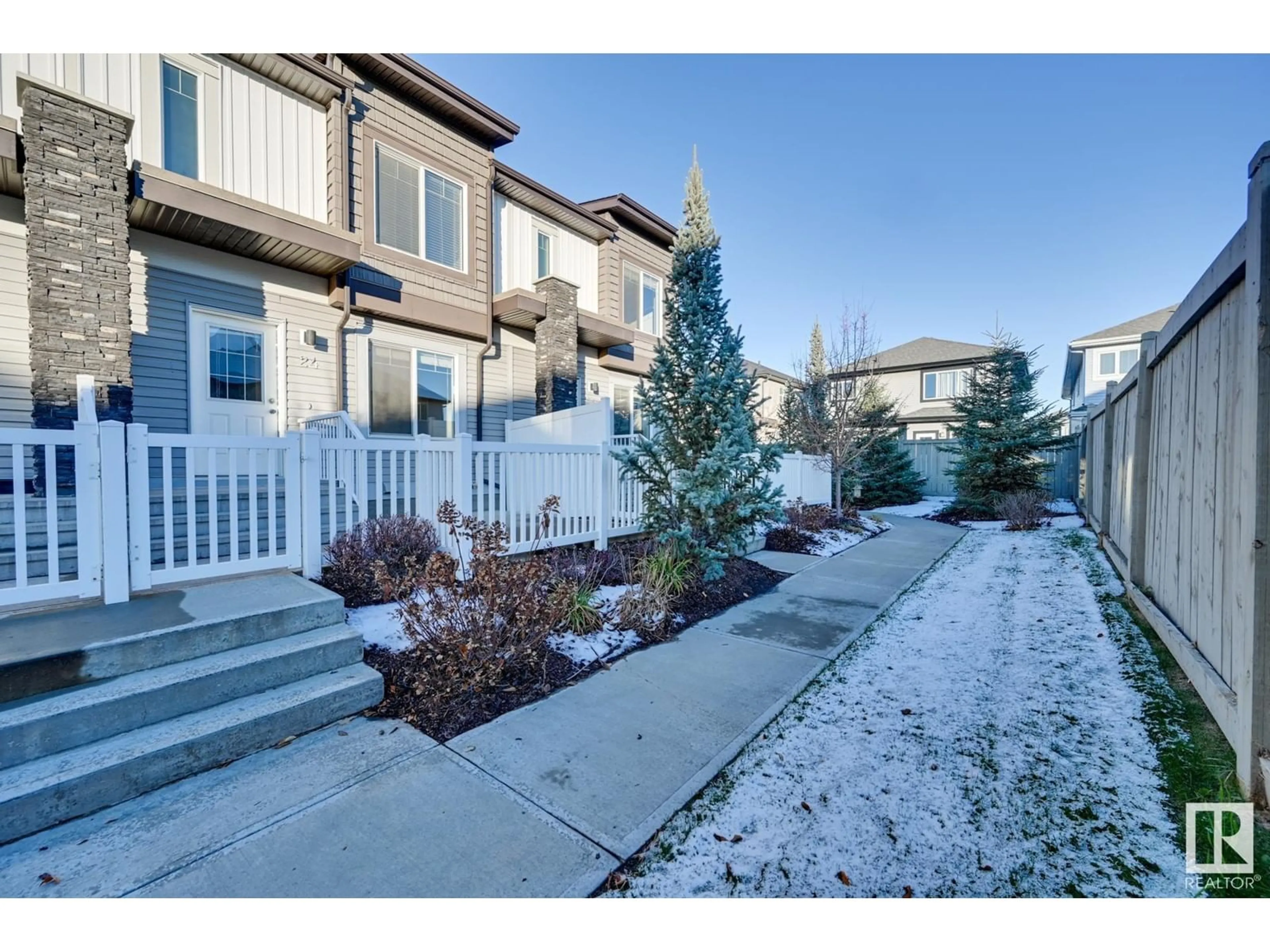 A pic from exterior of the house or condo, the fenced backyard for #24 2215 24 ST NW, Edmonton Alberta T6T1A6