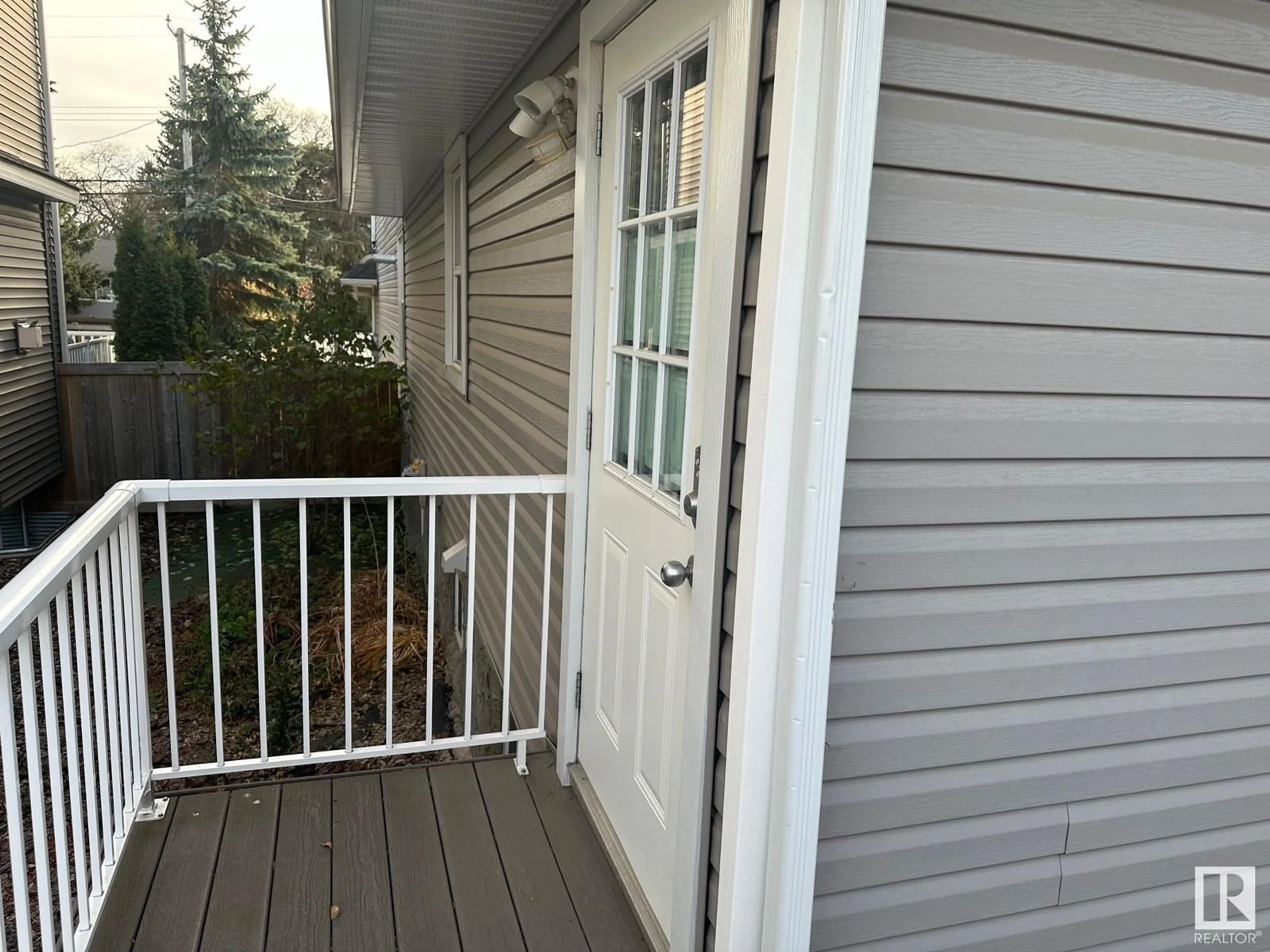 A pic from exterior of the house or condo, the fenced backyard for 11231 75 AV NW, Edmonton Alberta T6G0H4