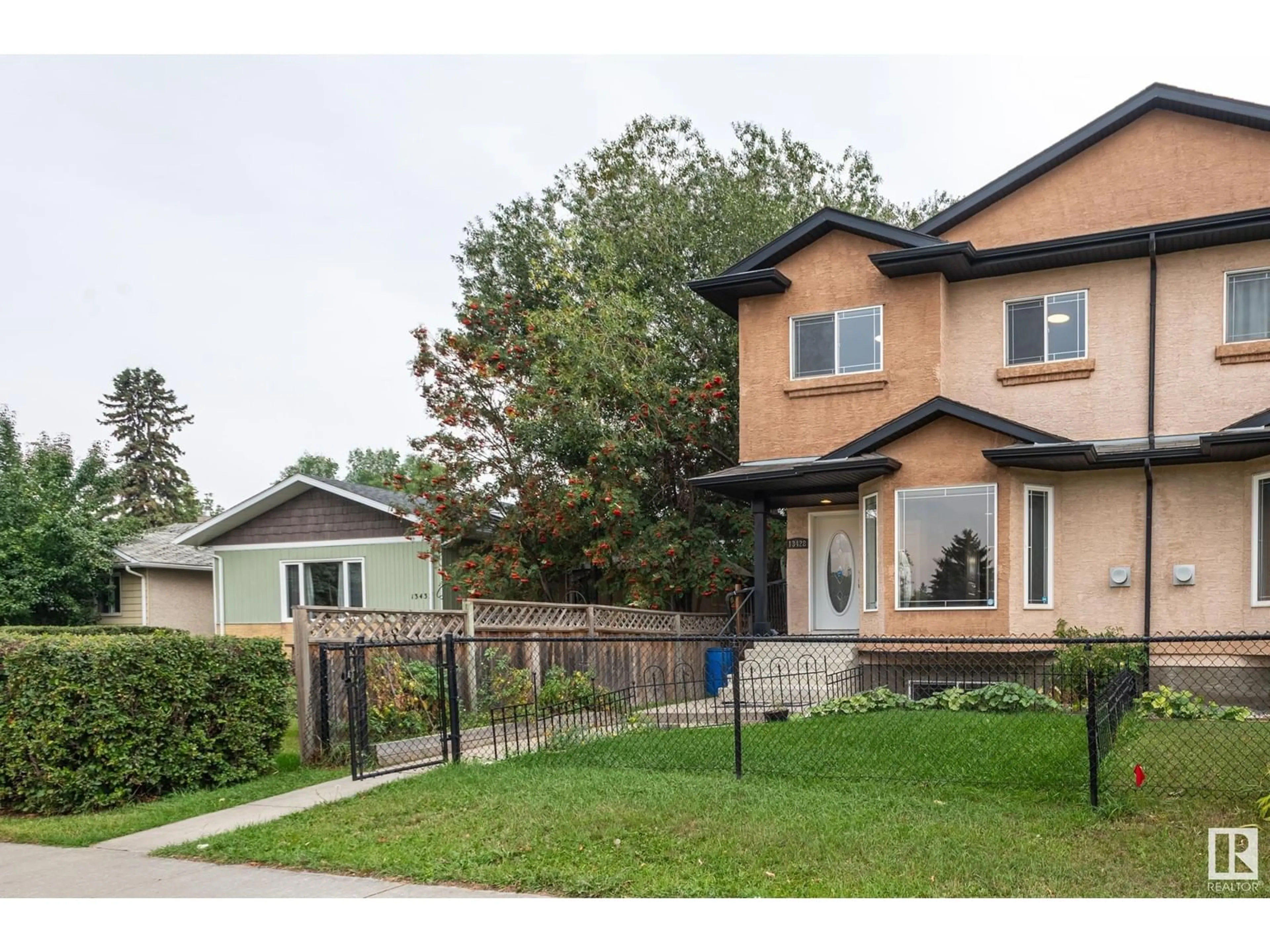 Frontside or backside of a home, the fenced backyard for 13428 118 AV NW, Edmonton Alberta T5L2L8