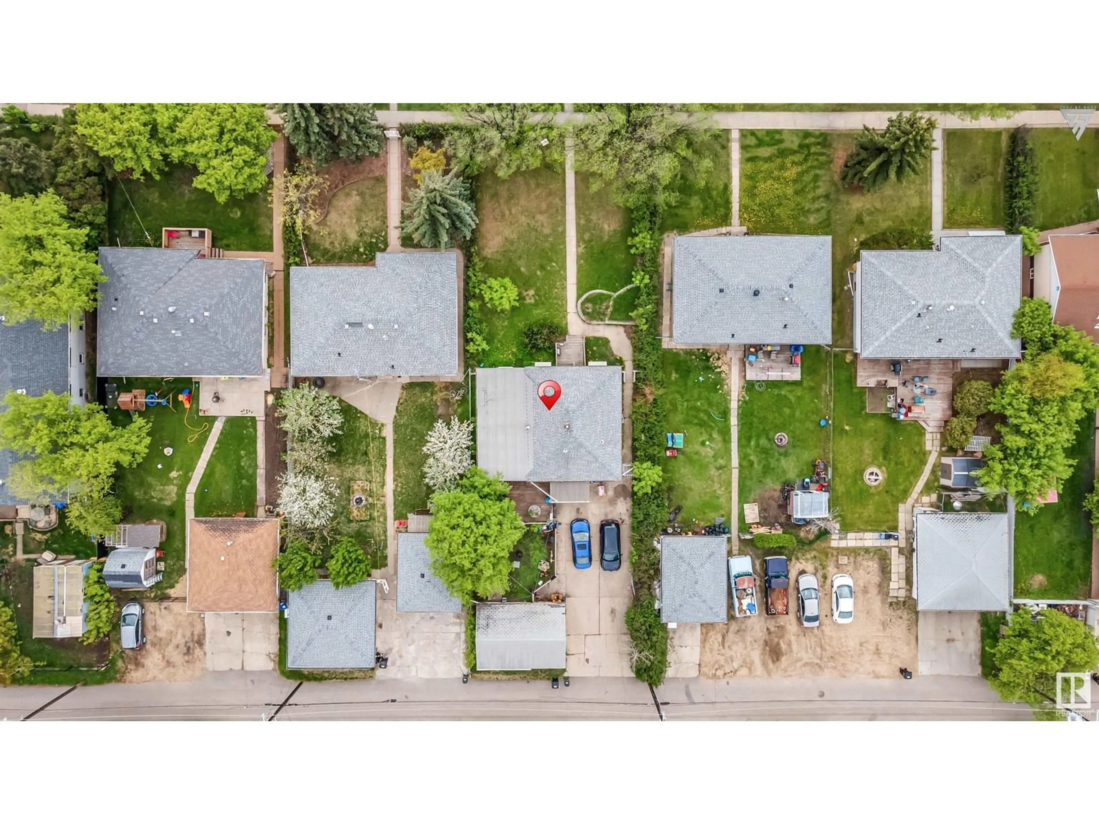 Frontside or backside of a home, the fenced backyard for 6016 101 AV NW, Edmonton Alberta T6A0G8