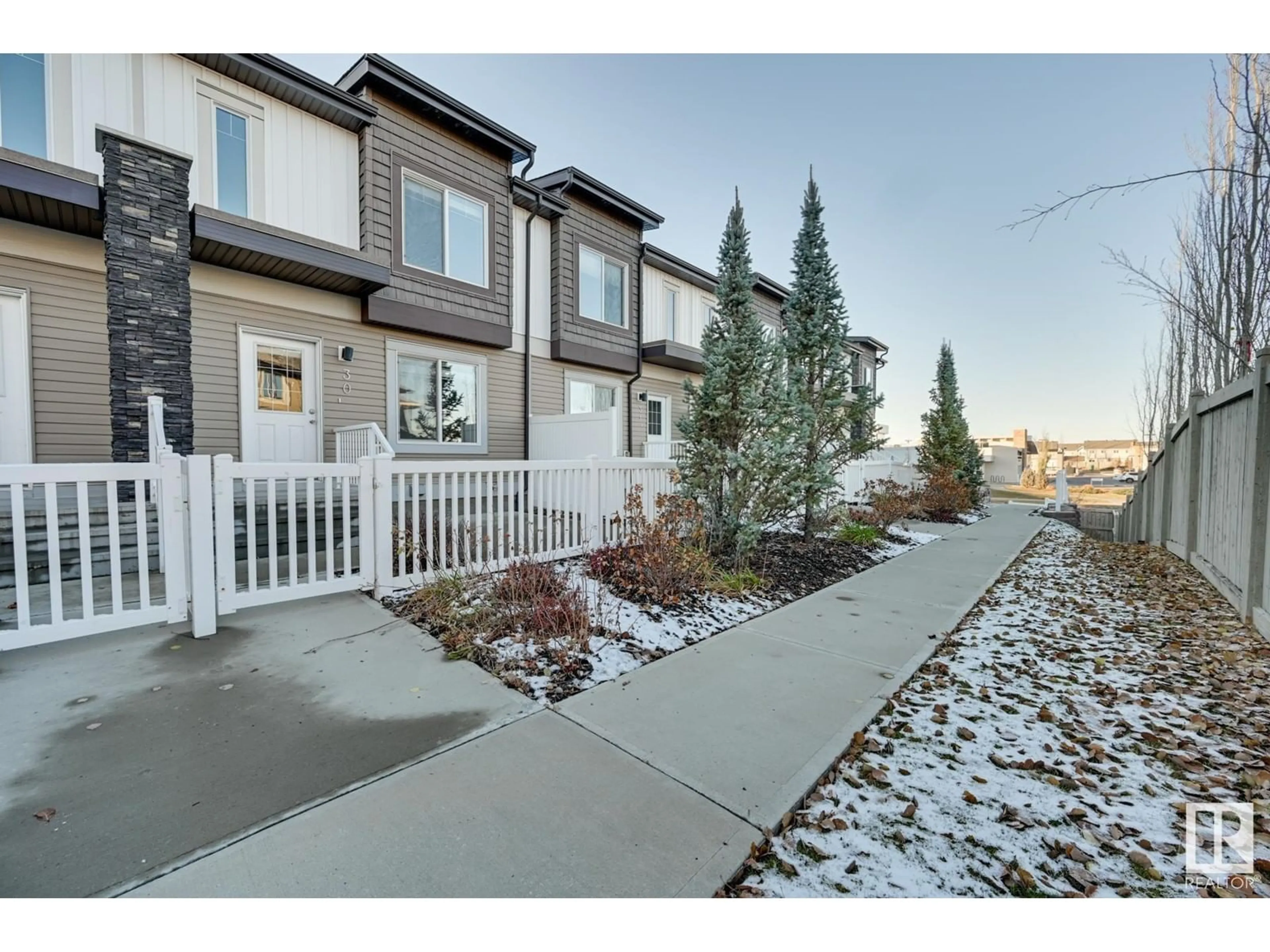 A pic from exterior of the house or condo, the fenced backyard for #30 2215 24 ST NW, Edmonton Alberta T6T1A6