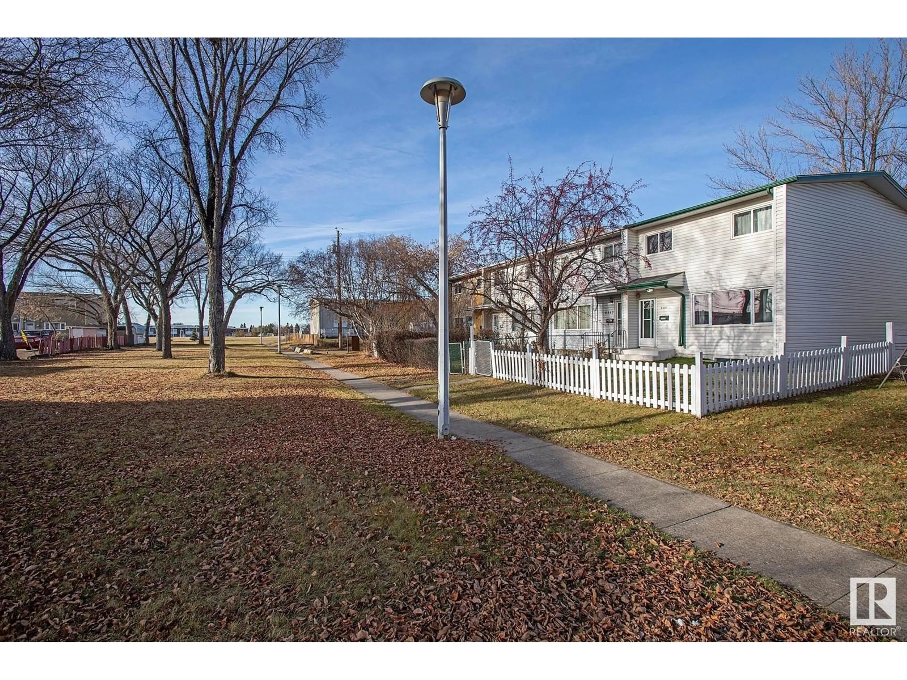 A pic from exterior of the house or condo, the fenced backyard for 8310 133 AV NW, Edmonton Alberta T5E1B8