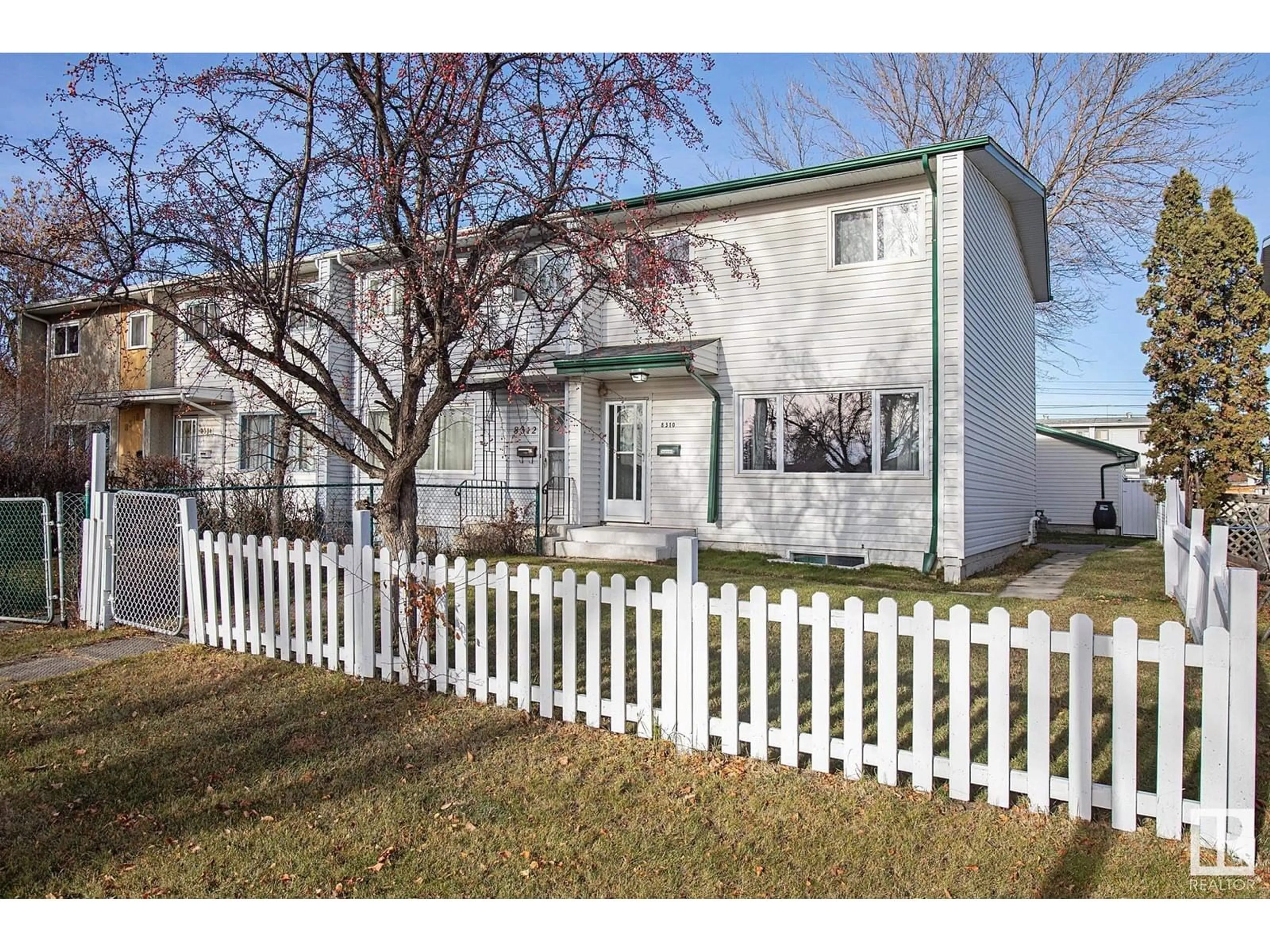 A pic from exterior of the house or condo, the fenced backyard for 8310 133 AV NW, Edmonton Alberta T5E1B8