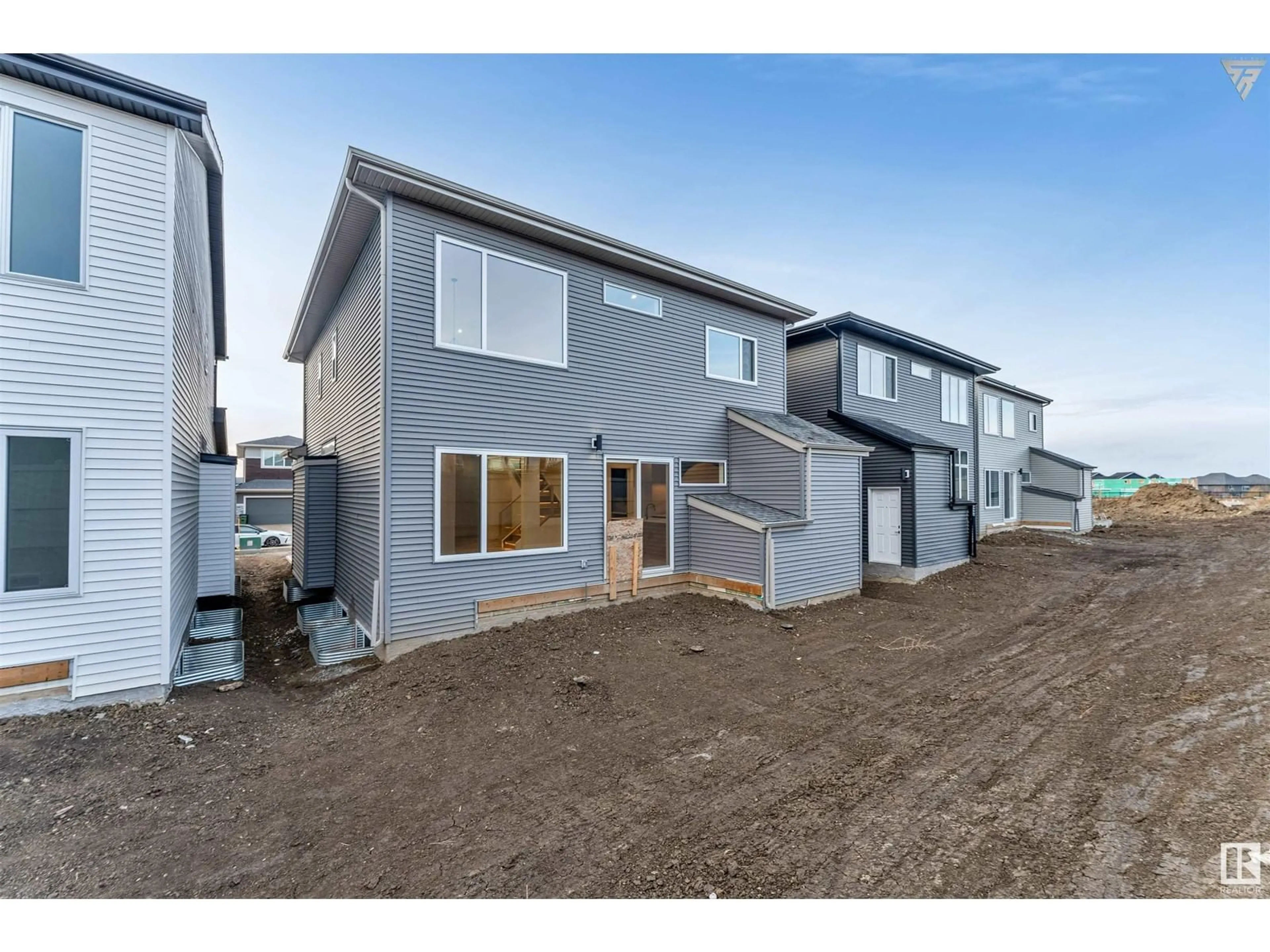 A pic from exterior of the house or condo, the fenced backyard for 7015 KIVIAQ CR SW, Edmonton Alberta T6W5N6