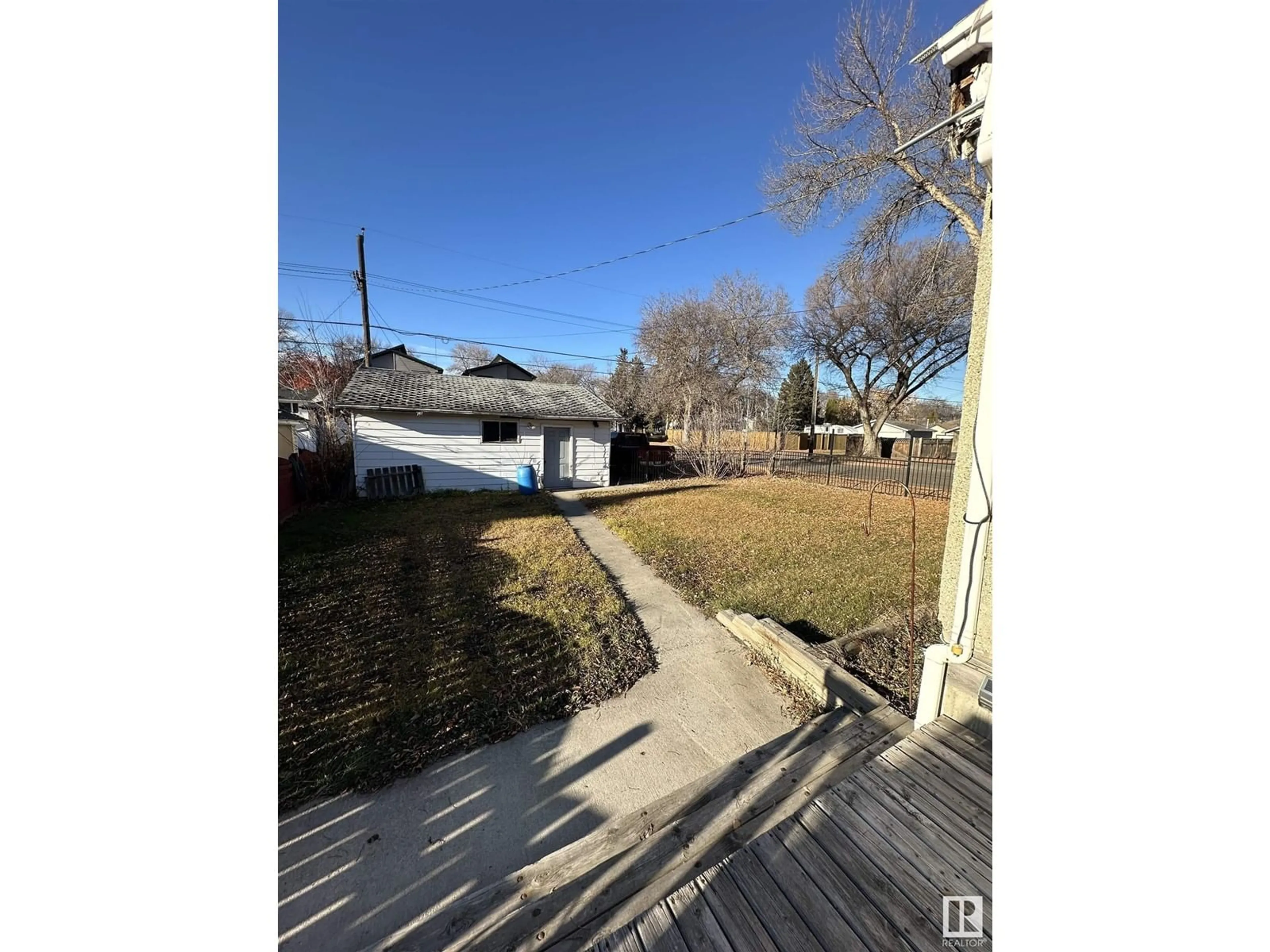 Frontside or backside of a home, the fenced backyard for 11942 37 ST NW, Edmonton Alberta T5W2C1