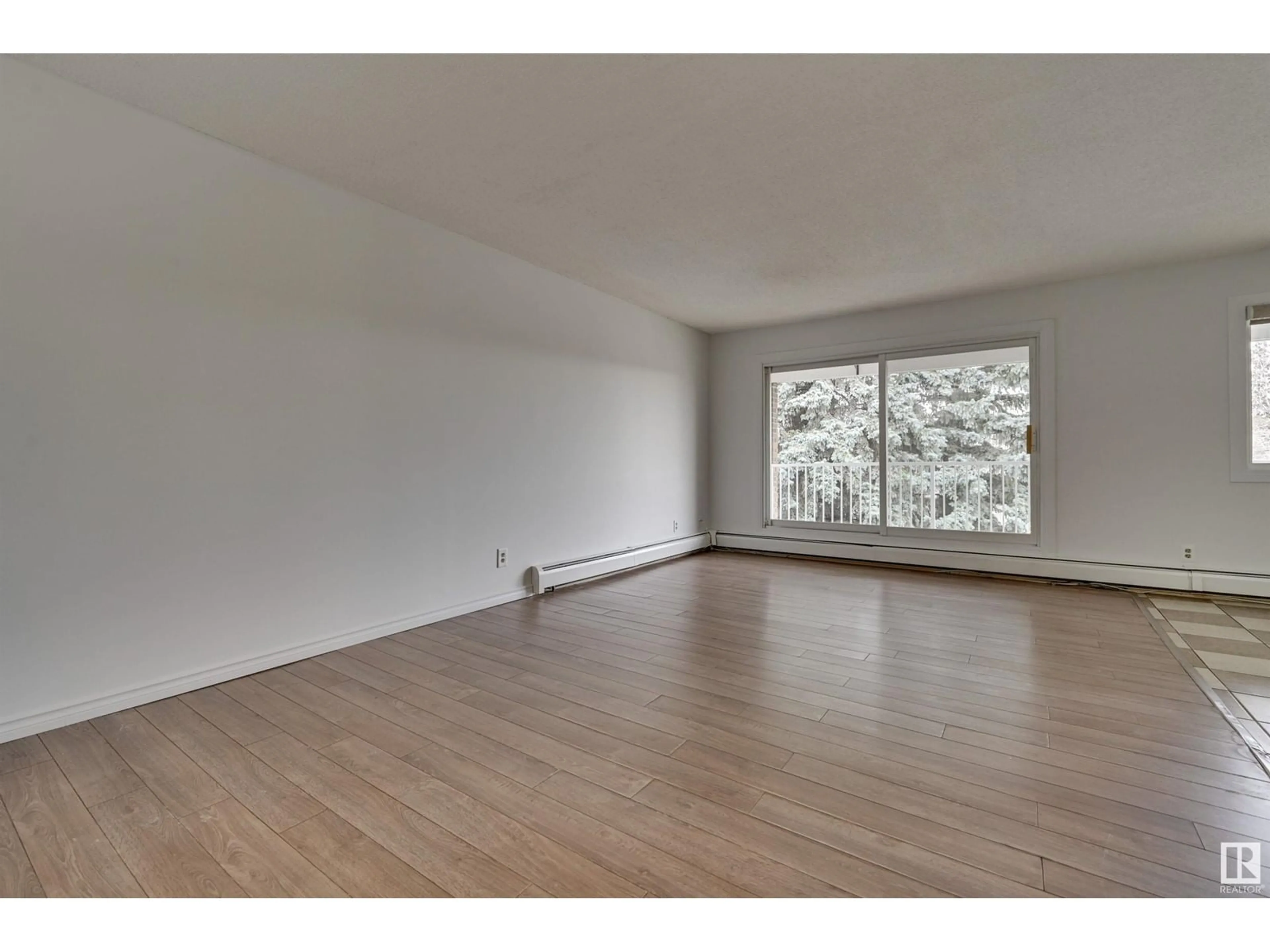 A pic of a room, wood floors for #308 14825 51 AV NW, Edmonton Alberta T6H5G4