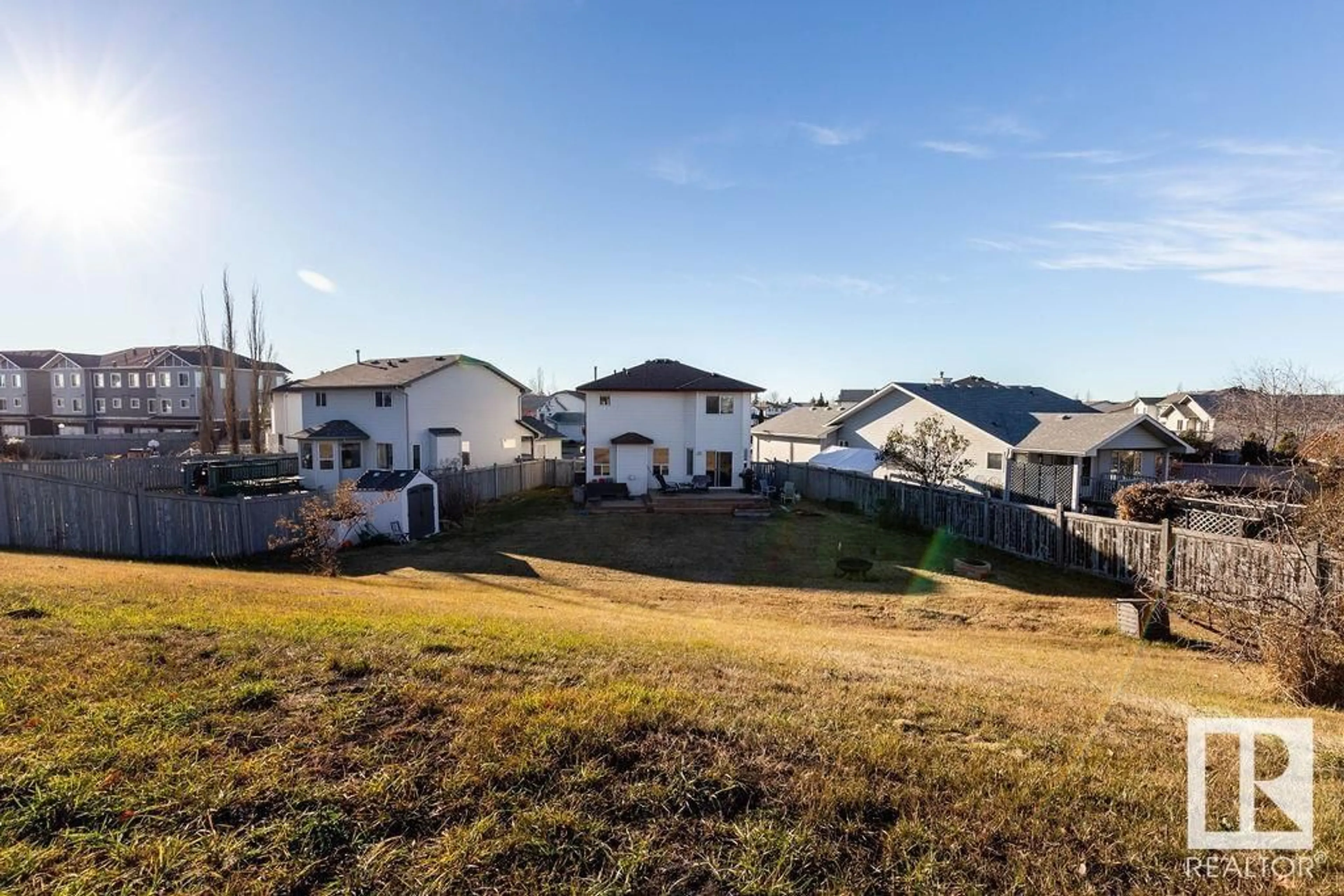 Frontside or backside of a home, the fenced backyard for 9806 179 AV NW, Edmonton Alberta T5X6A6