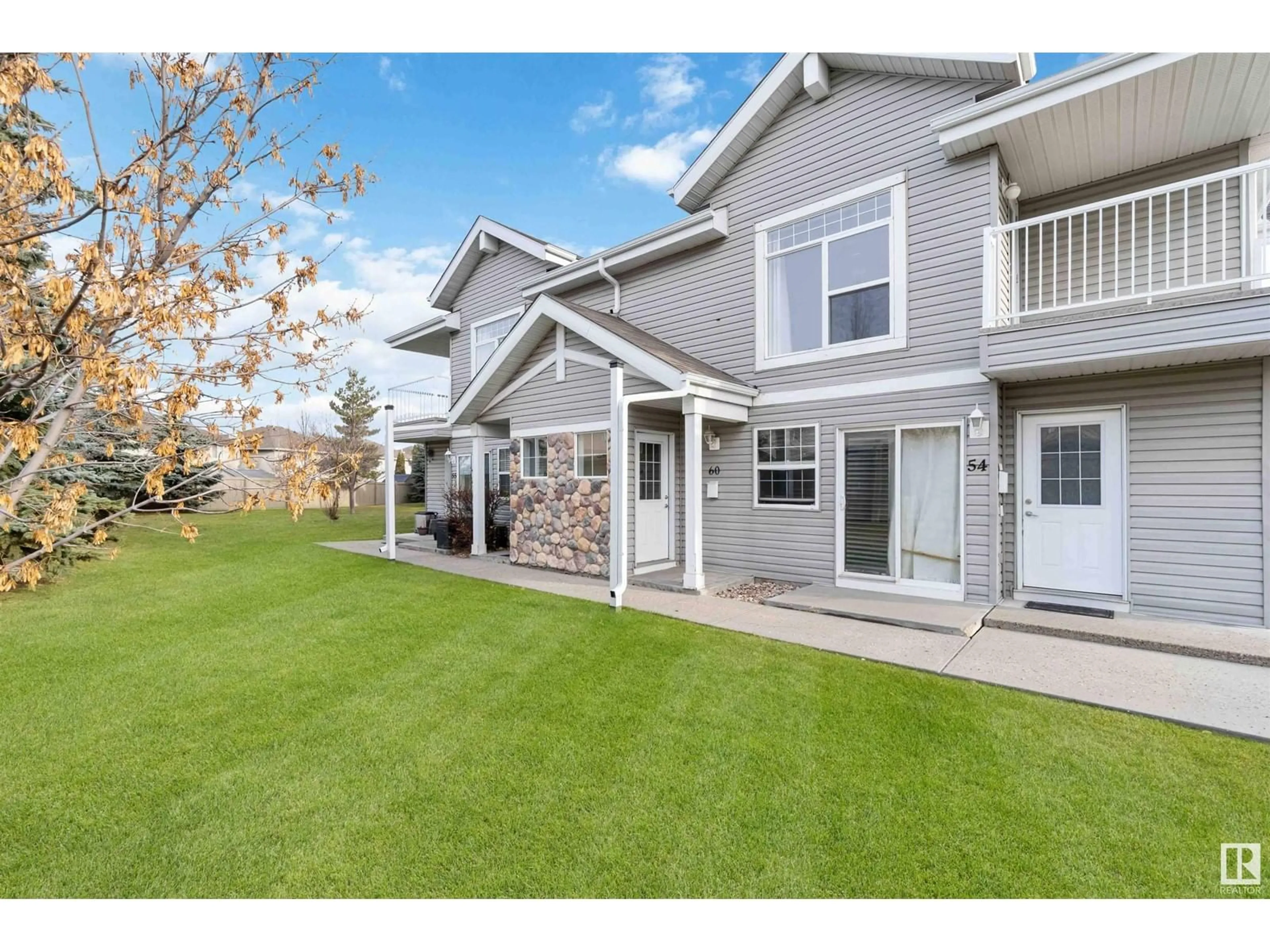 A pic from exterior of the house or condo, the fenced backyard for #60 150 EDWARDS DR SW, Edmonton Alberta T6X1M4