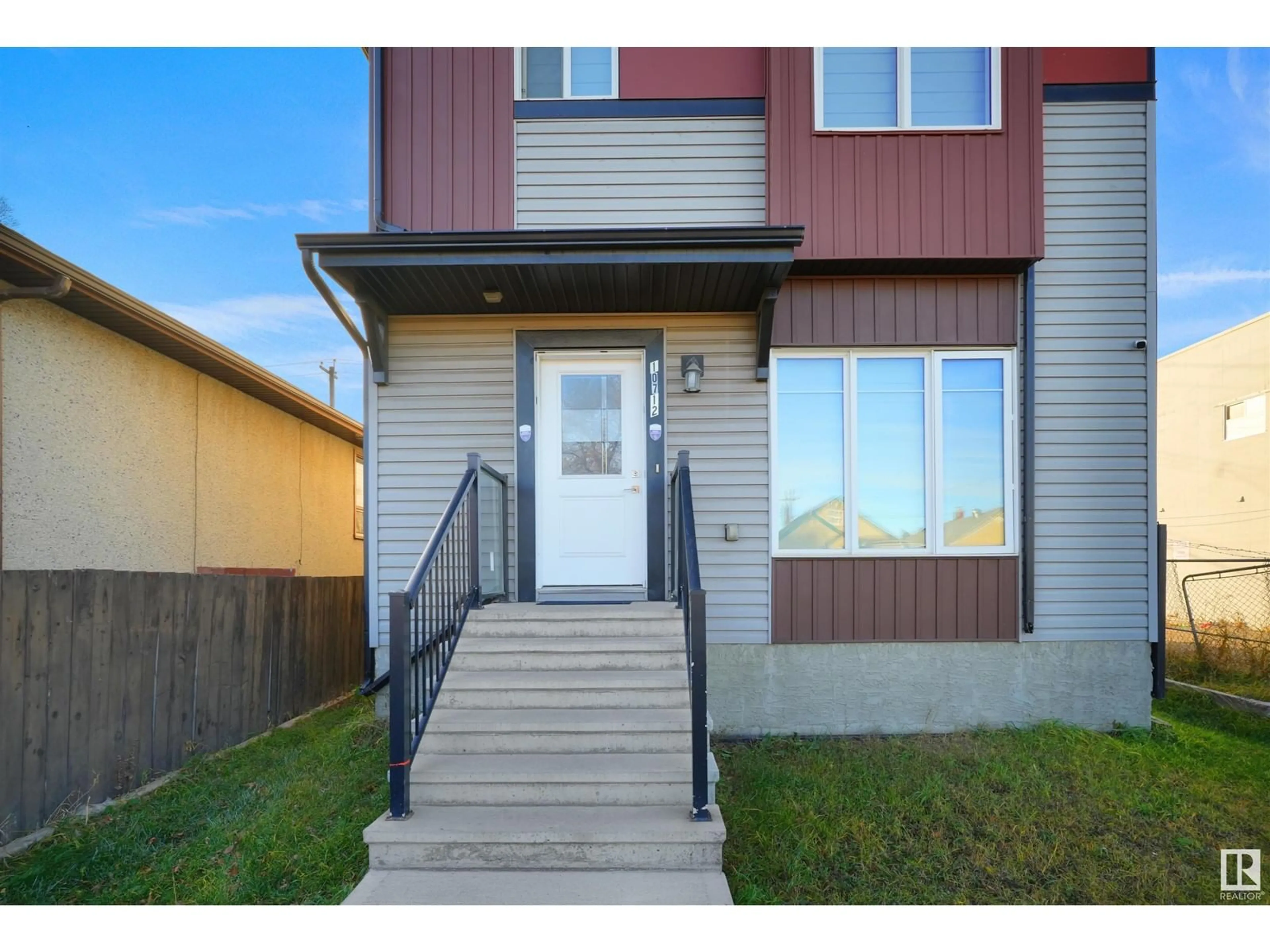 A pic from exterior of the house or condo, the fenced backyard for 10712 95 ST NW, Edmonton Alberta T5H2C7