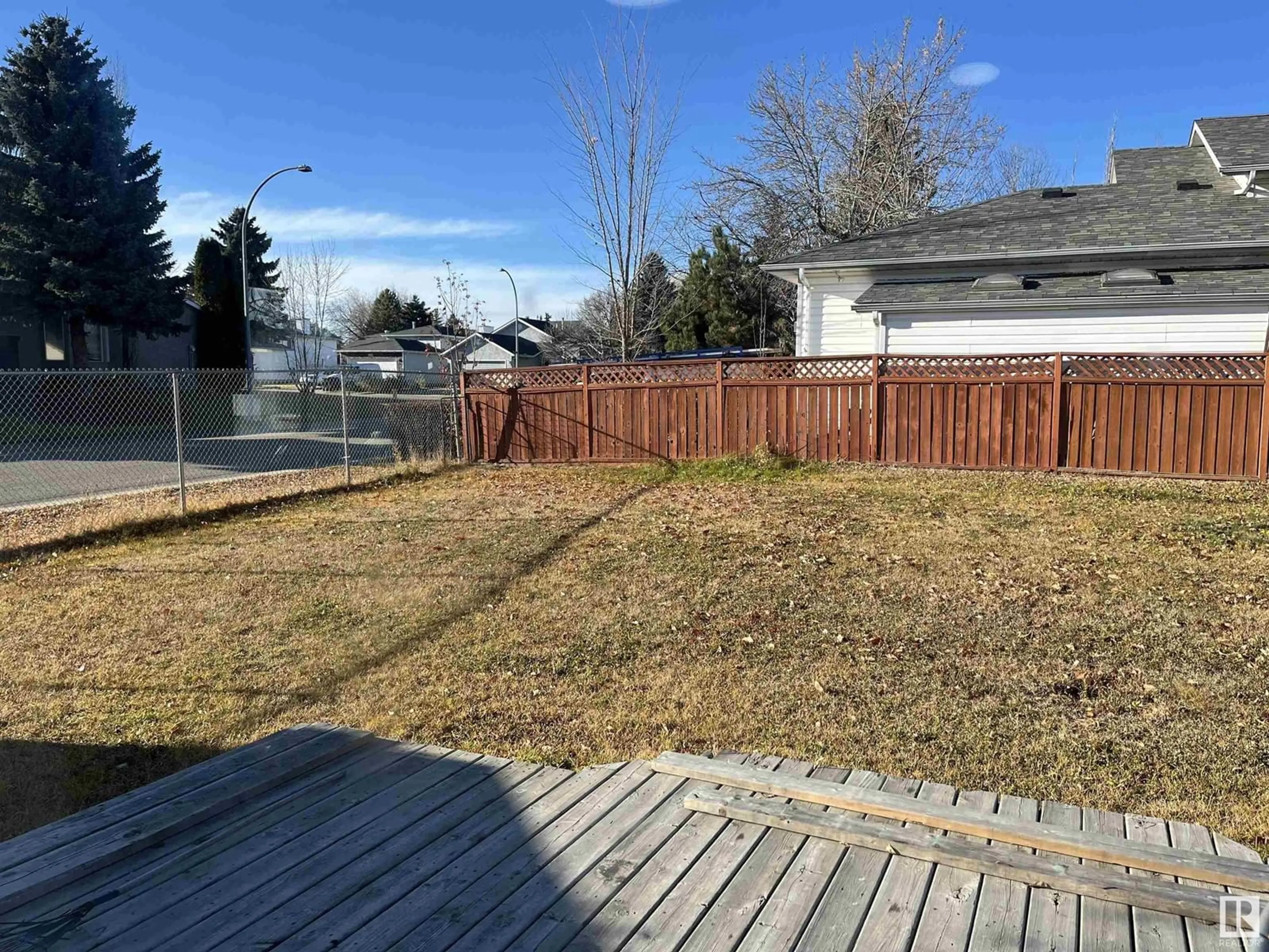 Frontside or backside of a home, the fenced backyard for 1504 48 ST NW, Edmonton Alberta T6L6H9