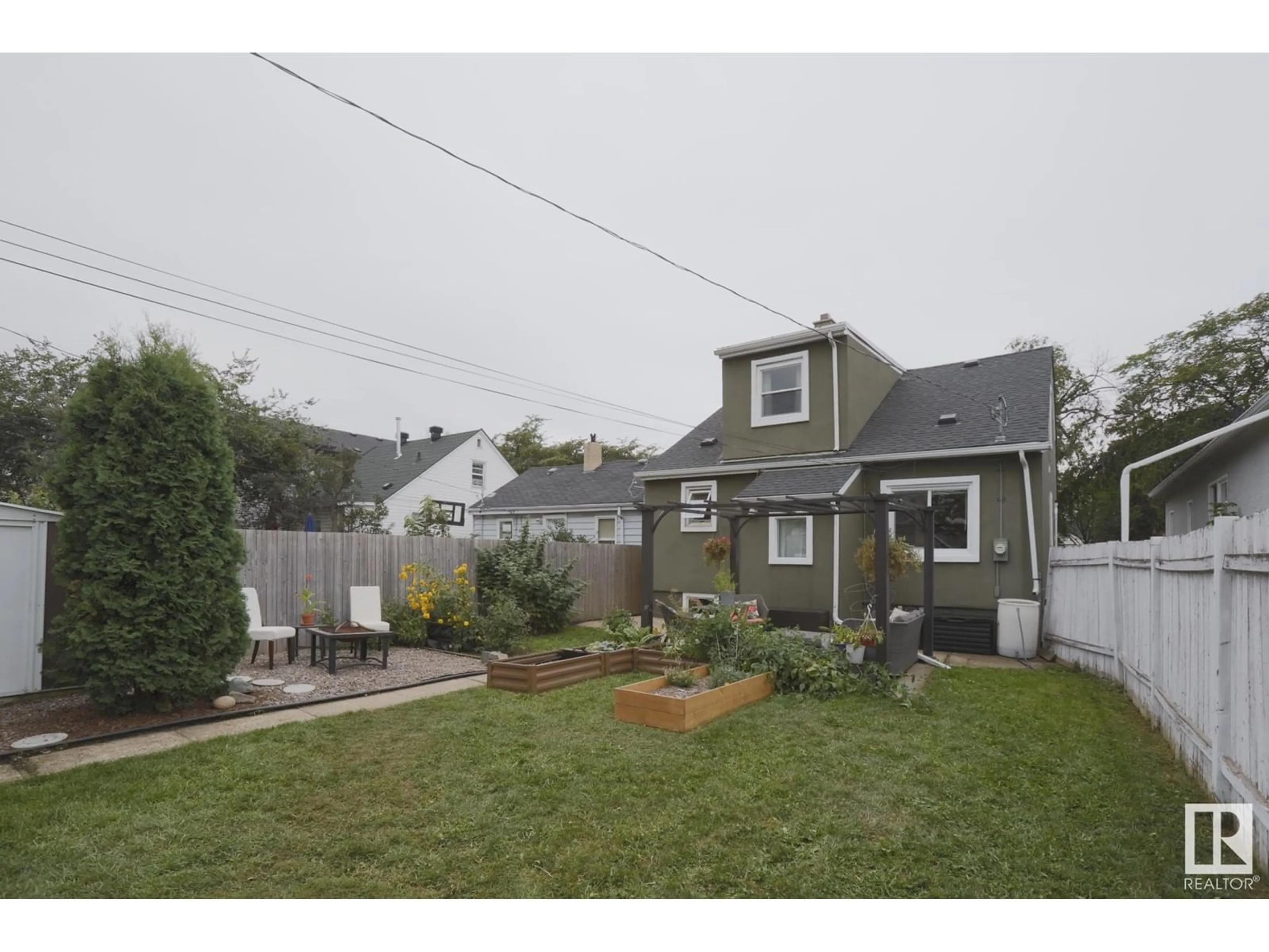 Frontside or backside of a home, the fenced backyard for 11617 101 ST NW, Edmonton Alberta T5G2B3