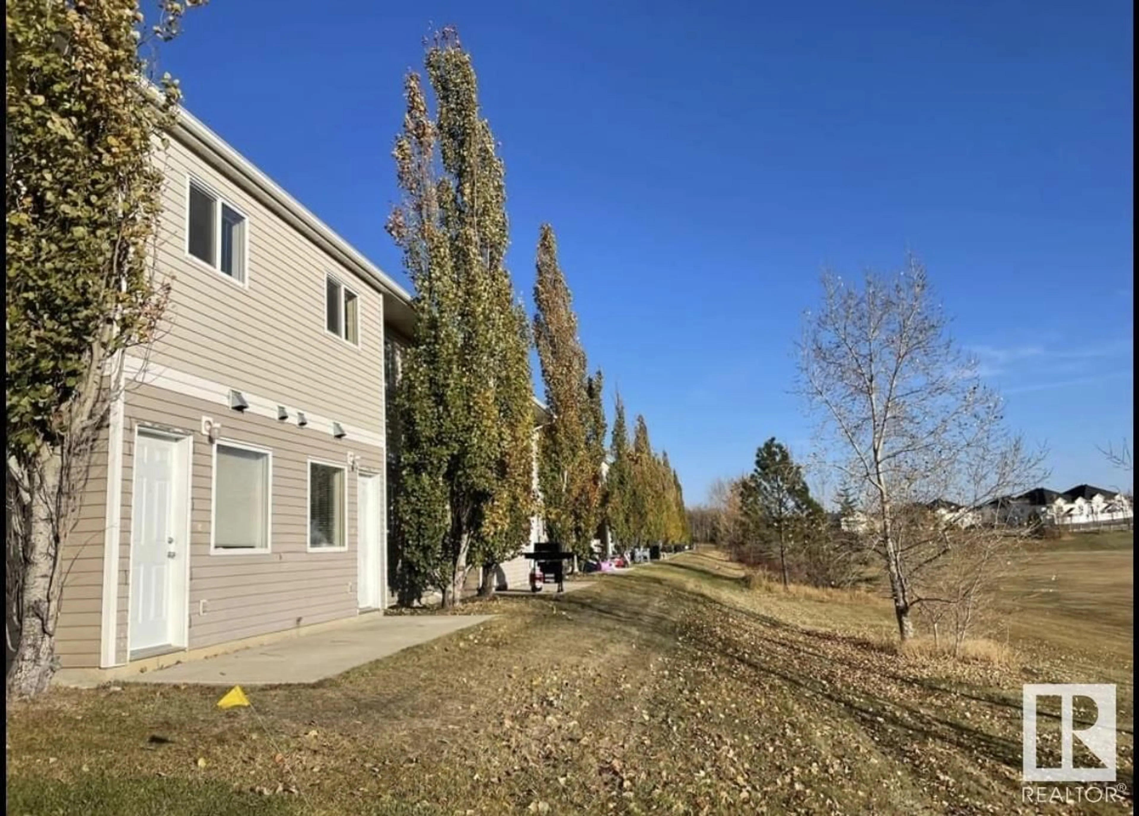 A pic from exterior of the house or condo, the fenced backyard for #526 100 Jordan PK, Red Deer Alberta T4P0B6