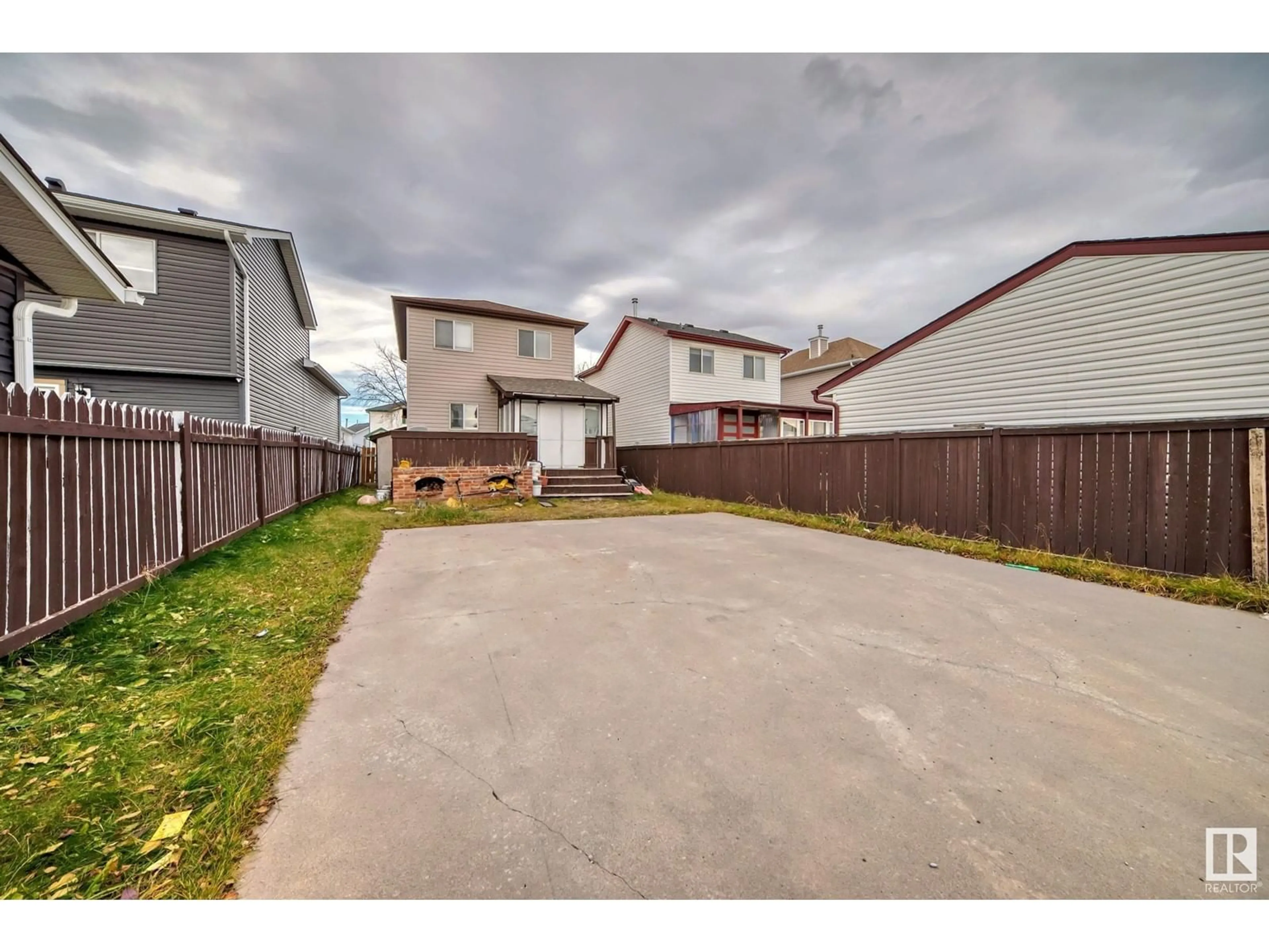 Frontside or backside of a home, the fenced backyard for 56 Martin Crossing Crescent NE, Calgary Alberta T3J3S8