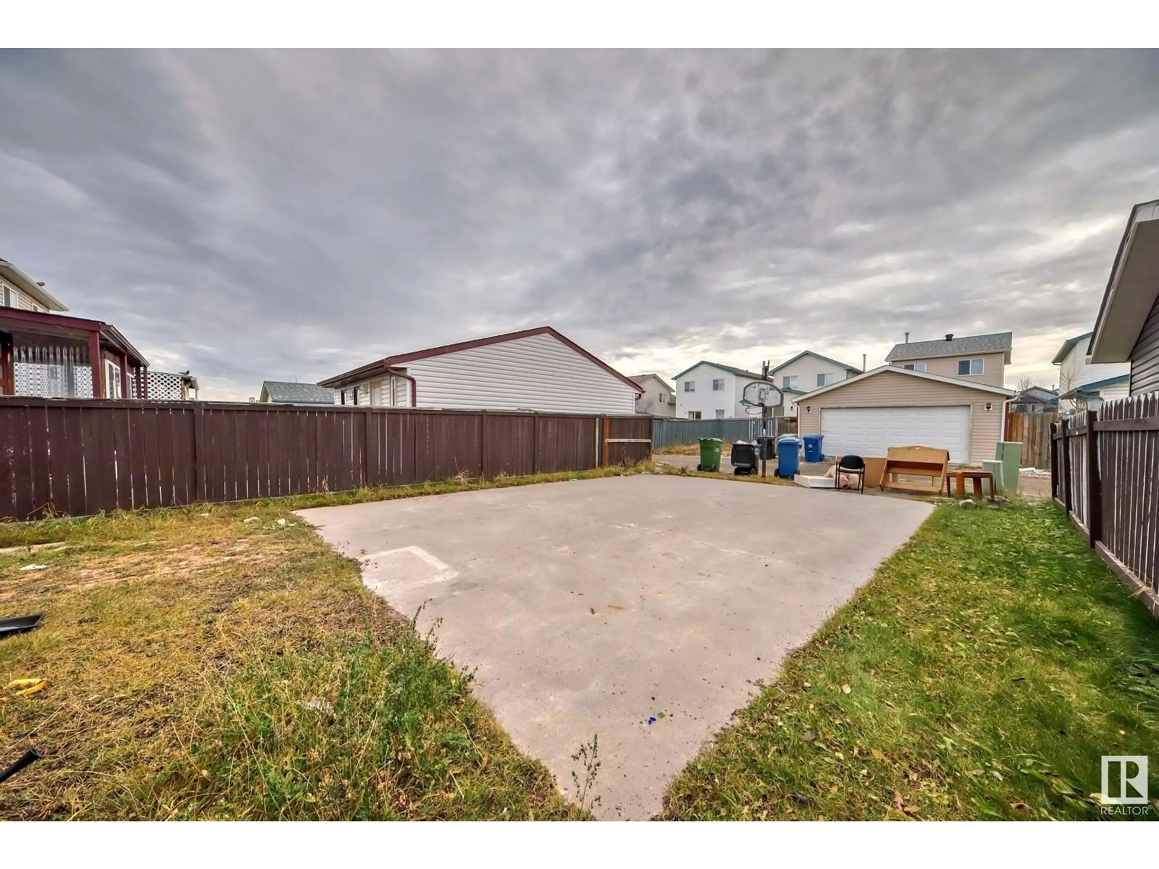 Frontside or backside of a home, the fenced backyard for 56 Martin Crossing Crescent NE, Calgary Alberta T3J3S8