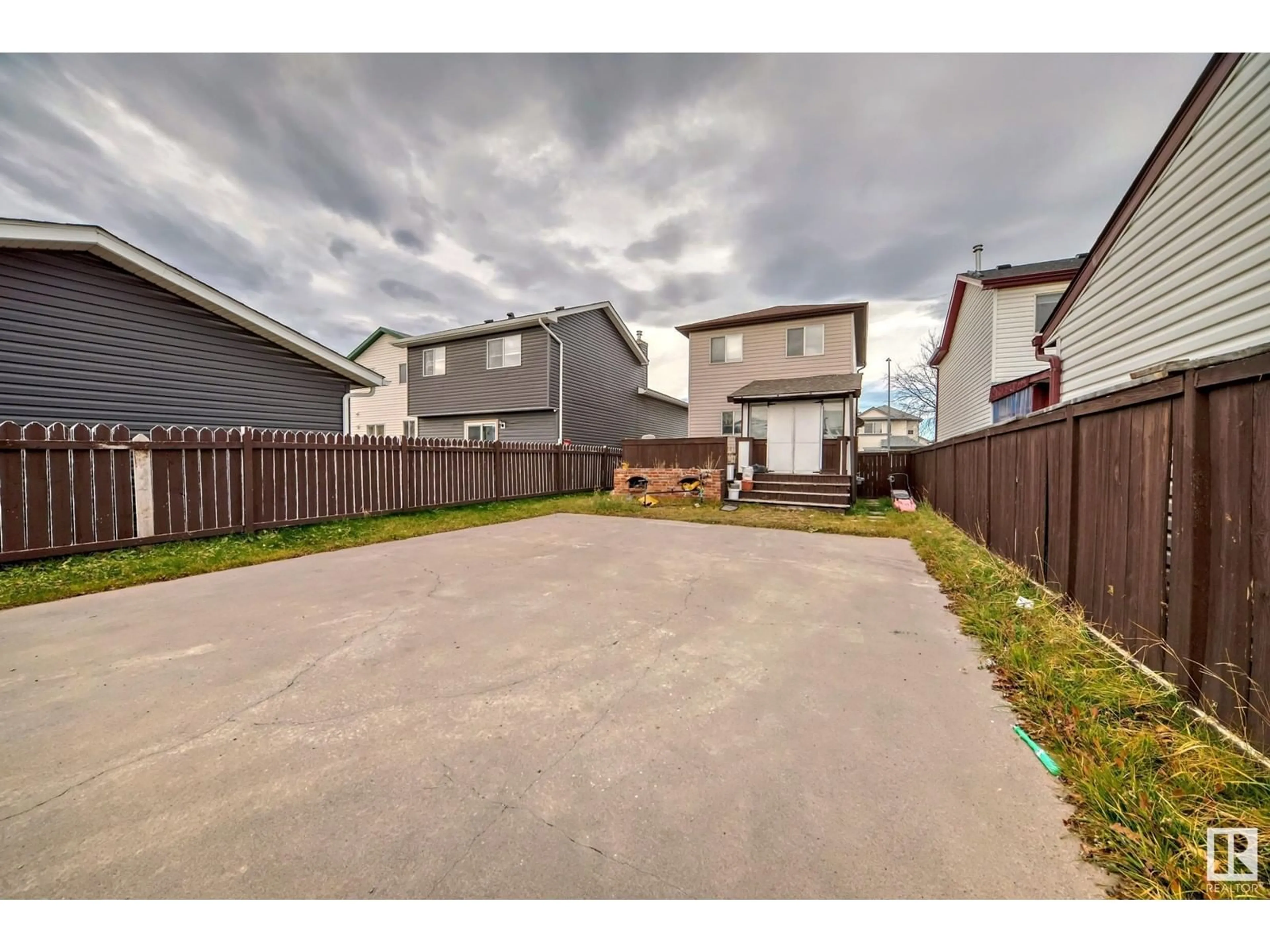 A pic from exterior of the house or condo, the fenced backyard for 56 Martin Crossing Crescent NE, Calgary Alberta T3J3S8