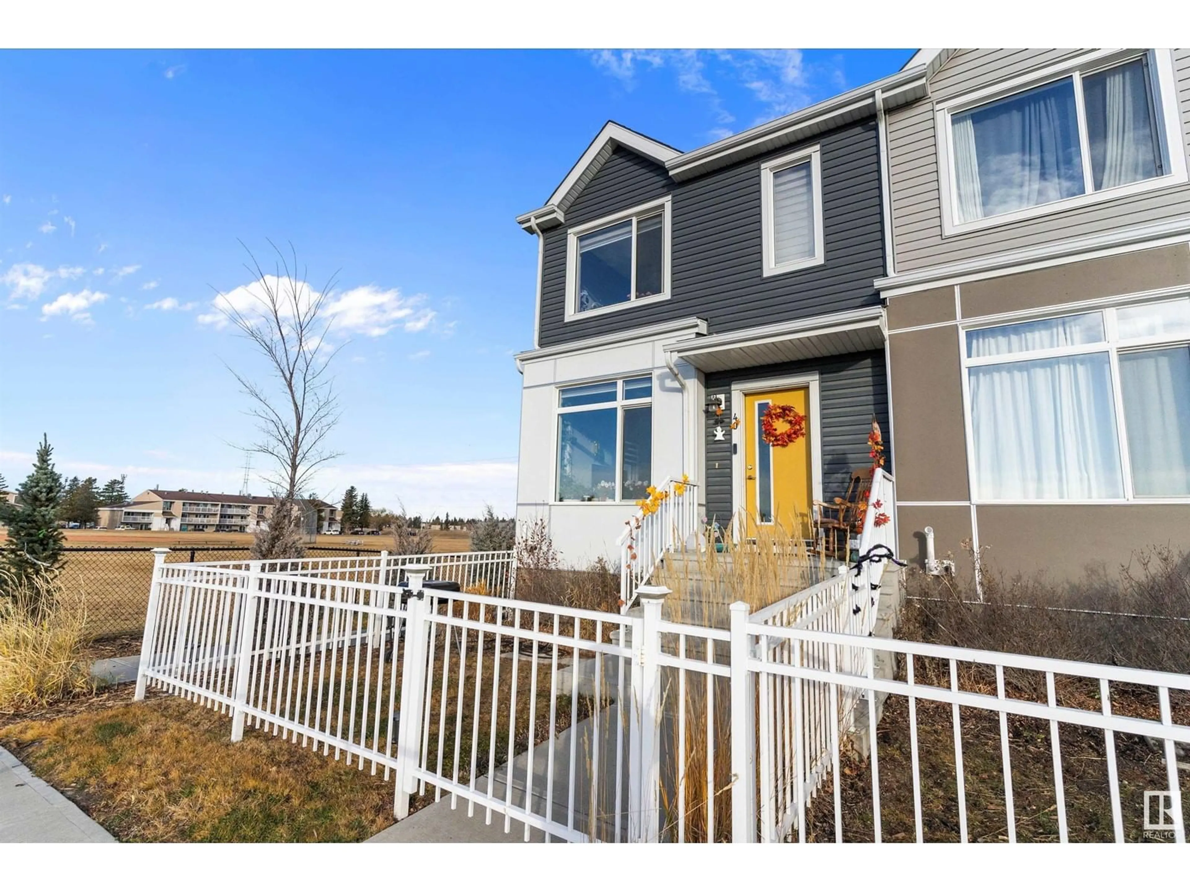 A pic from exterior of the house or condo, the fenced backyard for #40 215 Saddleback rd NW, Edmonton Alberta T6J5T6