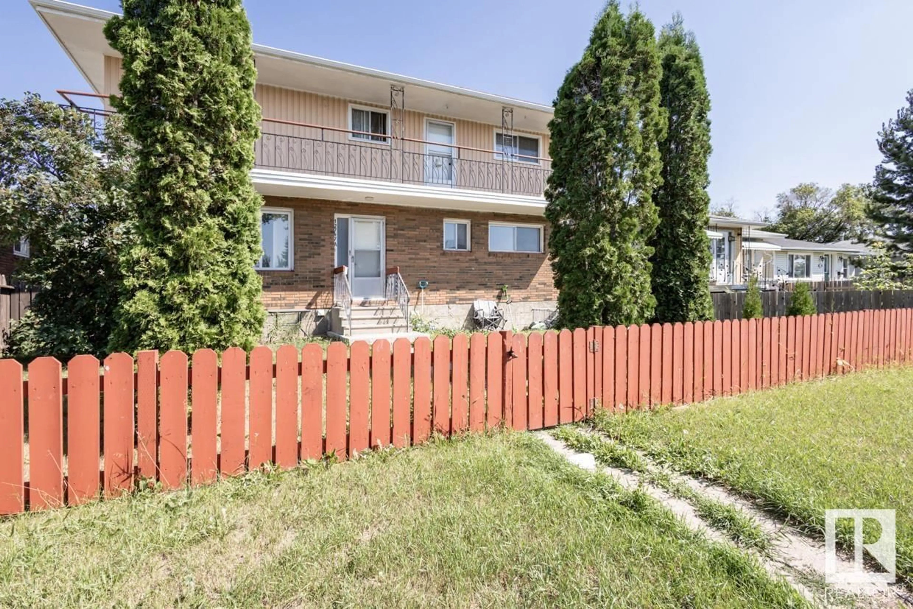 A pic from exterior of the house or condo, the fenced backyard for 12747 128 ST NW, Edmonton Alberta T5L1E2